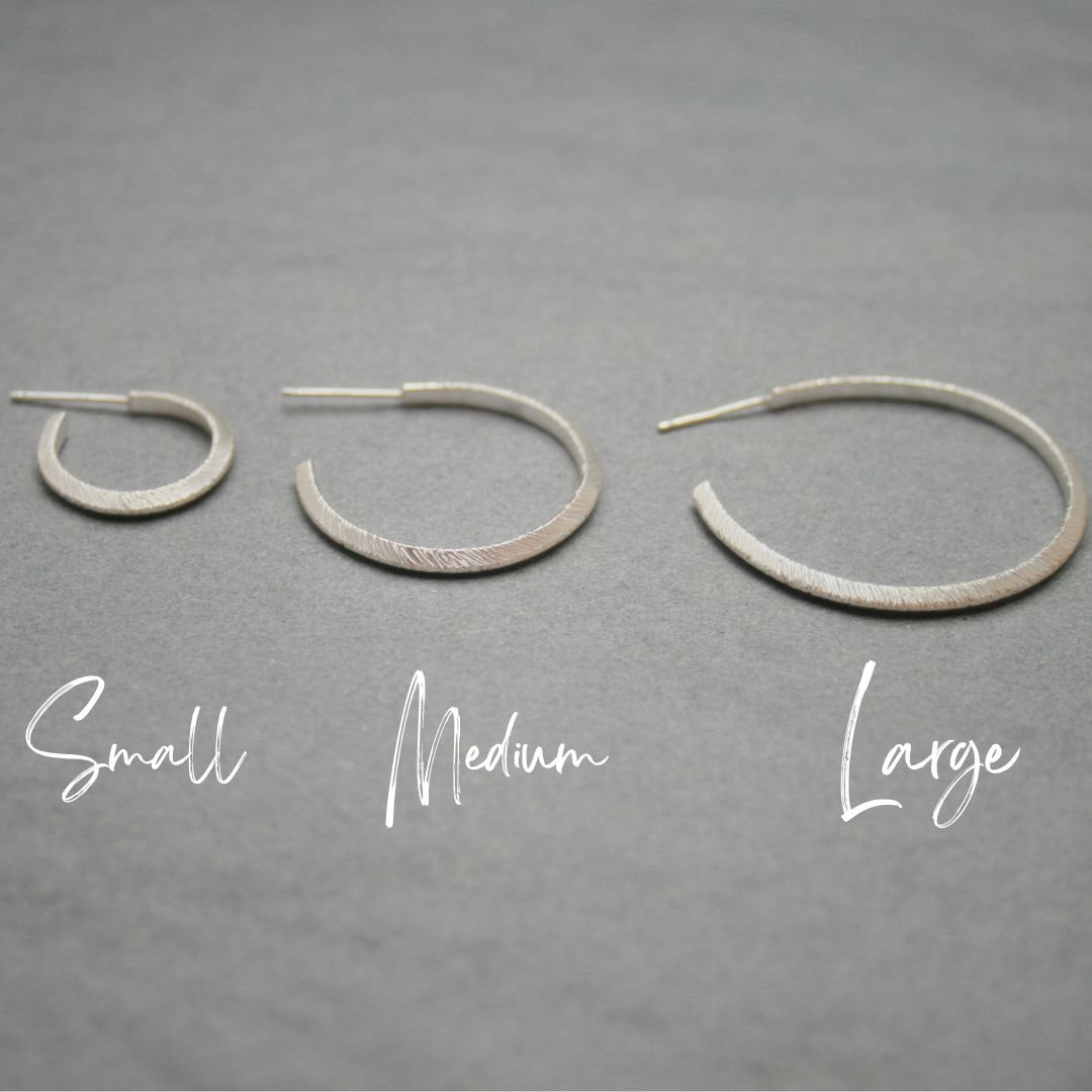 Close-up of Textured Geometric Hoop Earrings in Sterling Silver, featuring a triangular design available in three different sizes, small, medium and large