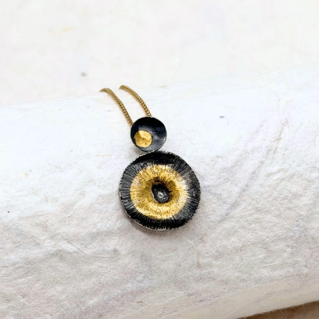 Side view of Echo silver and gold pendant on a gold-filled chain