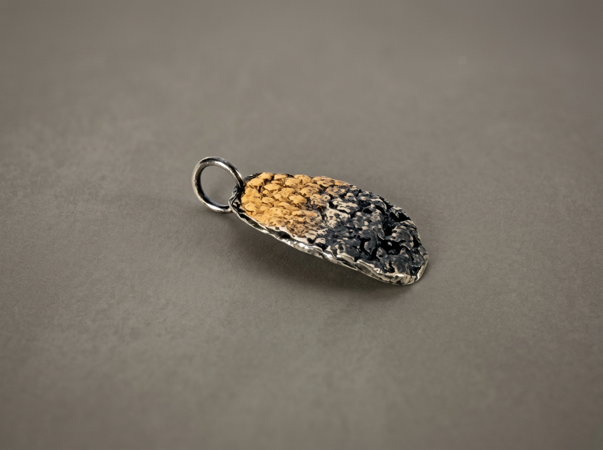 Close-up of the 23.5k gold keum-boo detail on the oxidized silver pendant