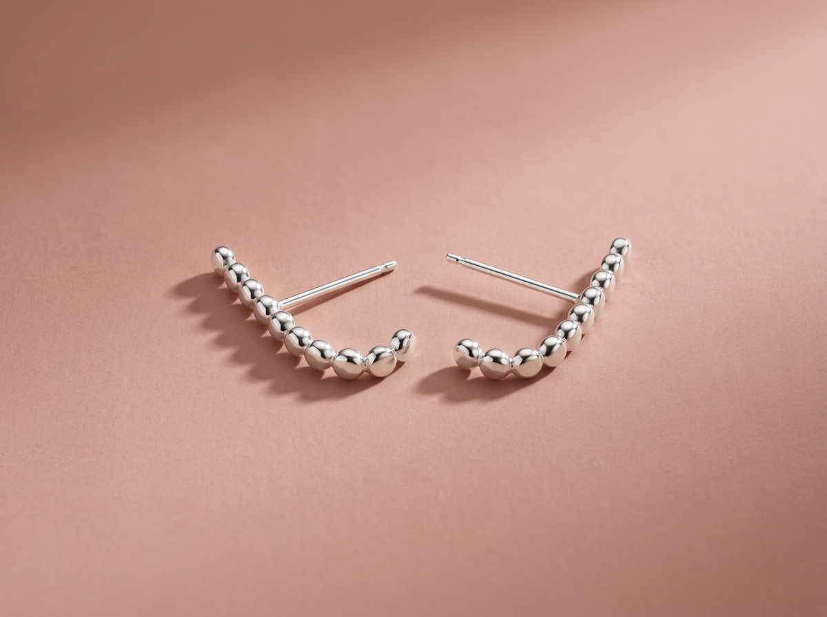 Pair of sterling silver half hoop earrings showing the open curve and post backs