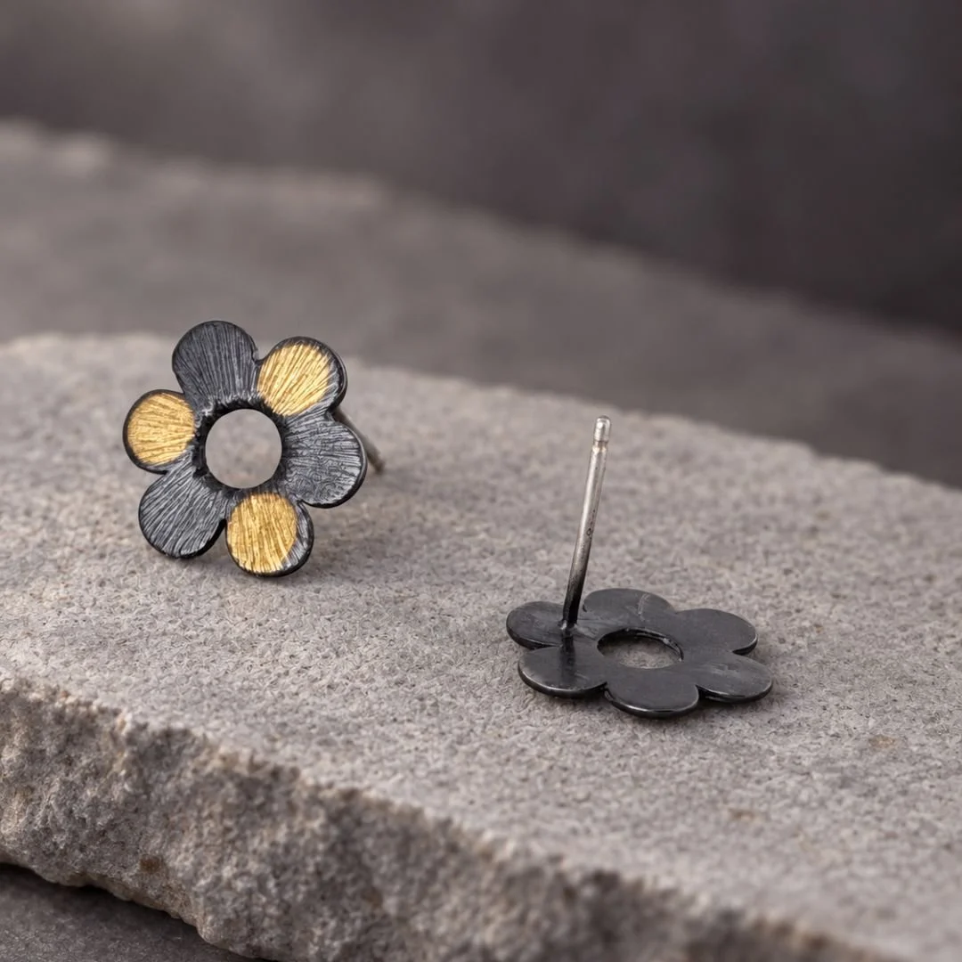 Front and back views of flower stud earrings, showing the oxidized silver reverse and straight post.
