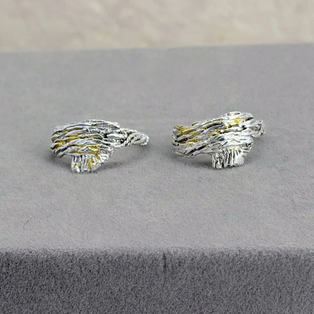 Two Bark Rings in sterling silver with keum-boo gold accents on a gray surface.