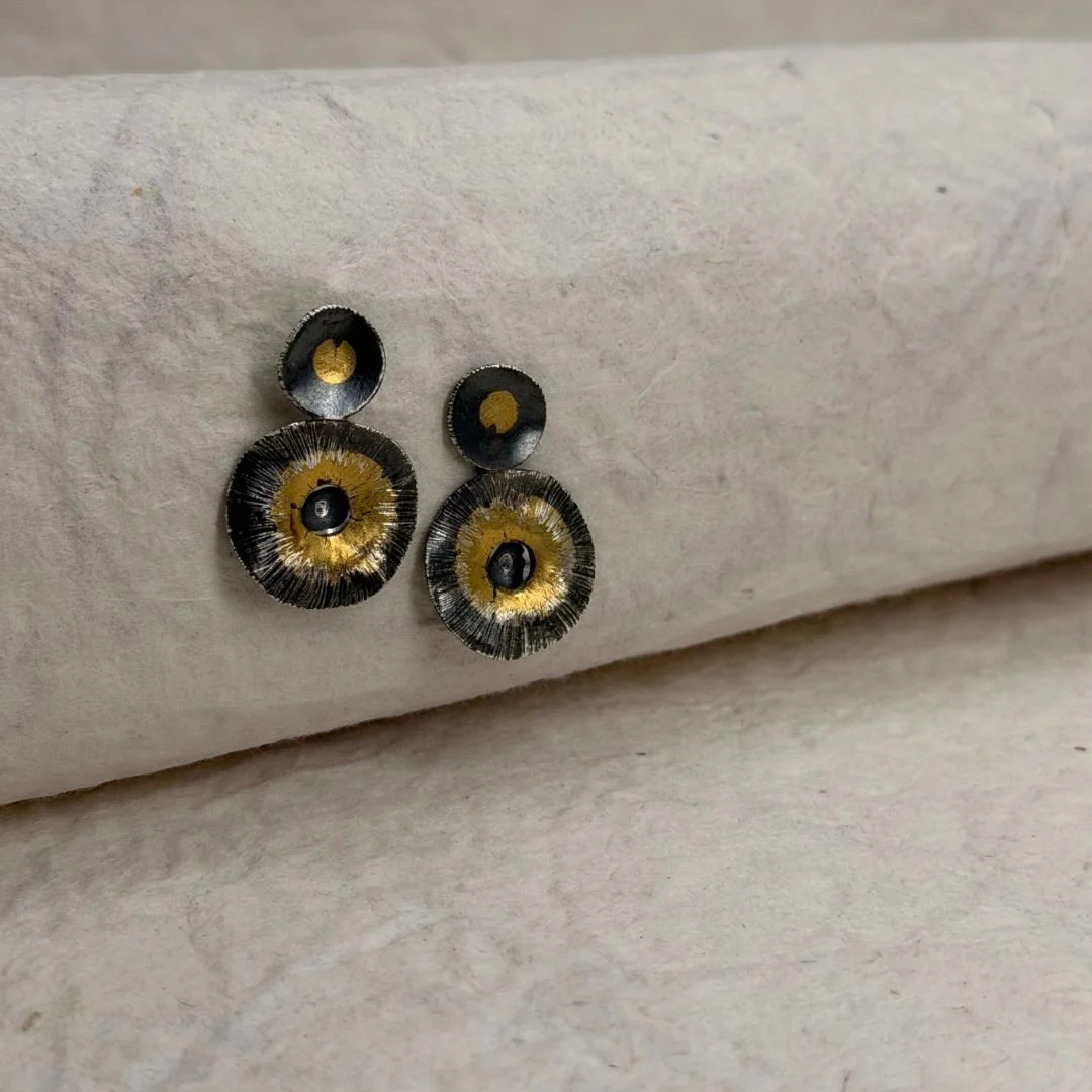 Close view of the irregular edges, dark silver texture, and keum-boo gold on Echo Earrings