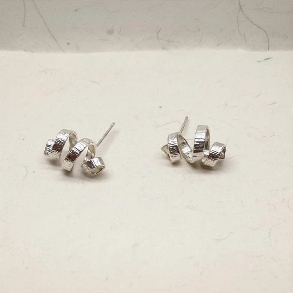 Mini Spiral studs  - sterling silver, worn close to the lobe