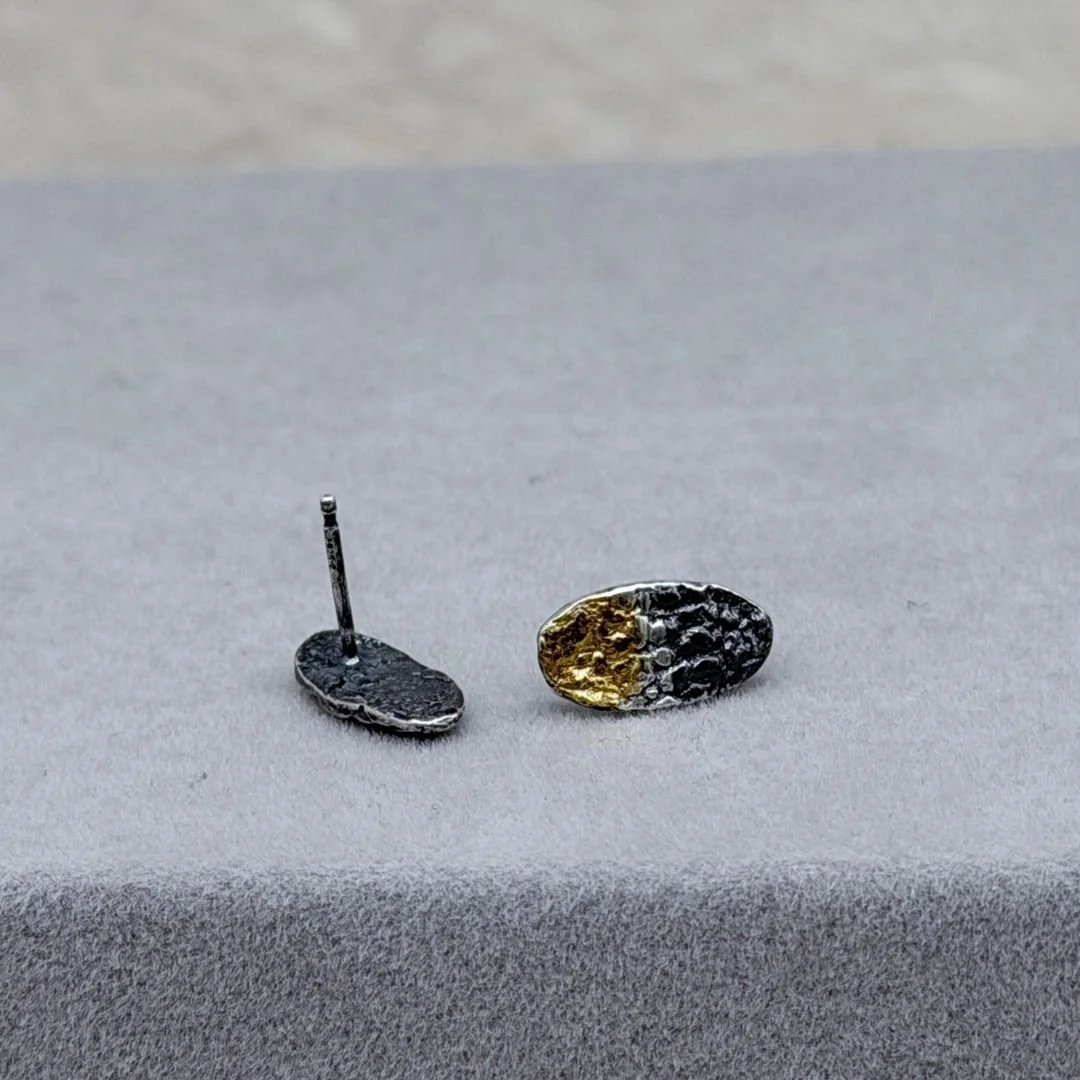Front and back of Petite Oval stud earrings, showing the ear post and keum-boo gold on oxidized sterling silver