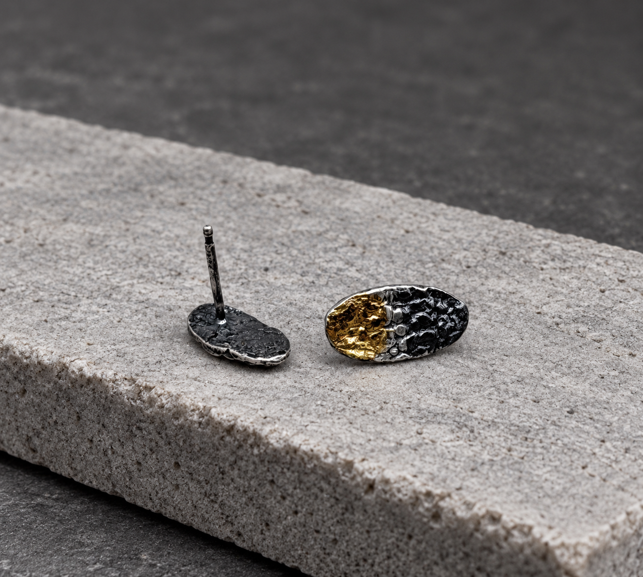 Front and back views of petite oval stud earrings, showing the textured surfaces and straight earring post.