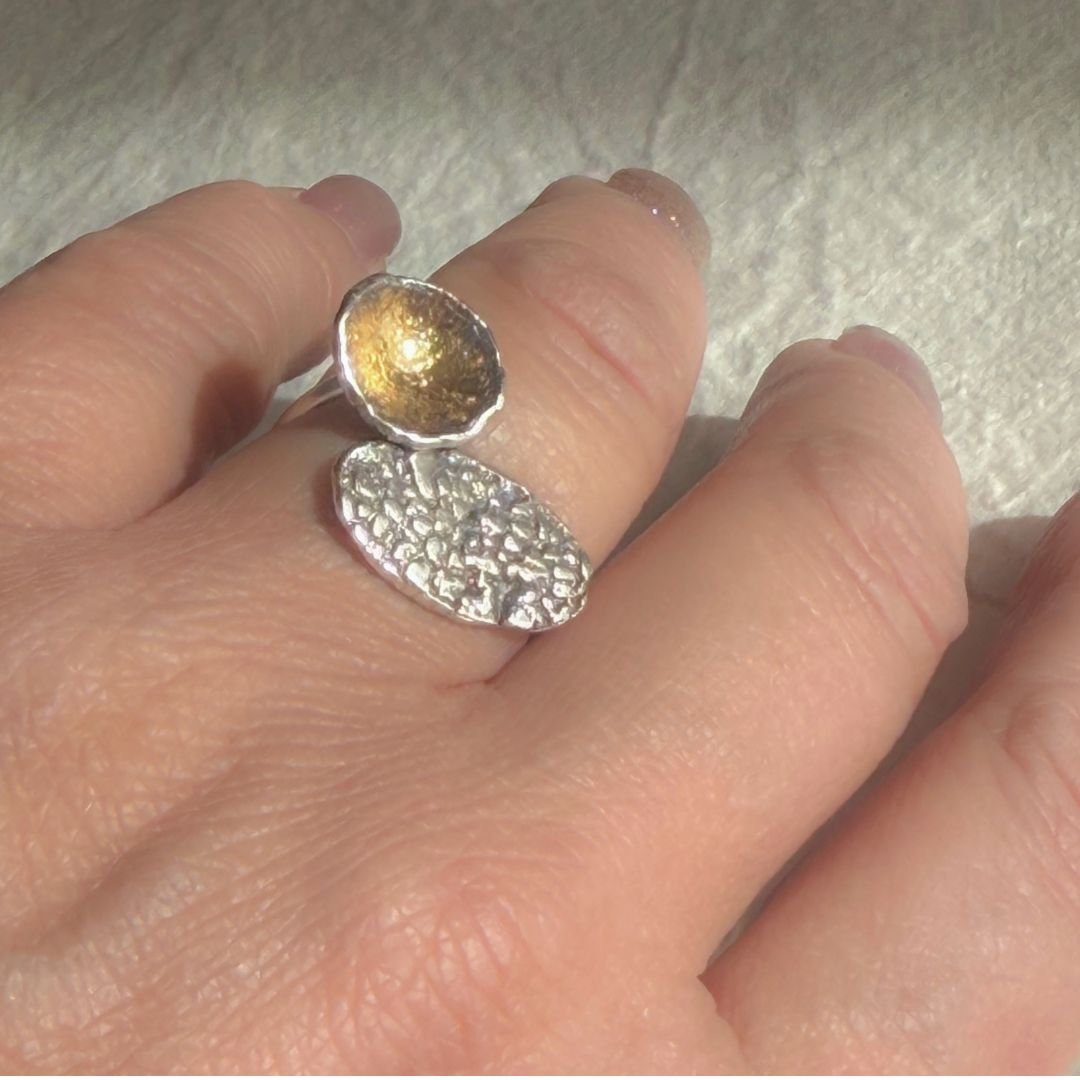 Oxidized silver and gold keum-boo statement ring worn on hand, showing scale and texture