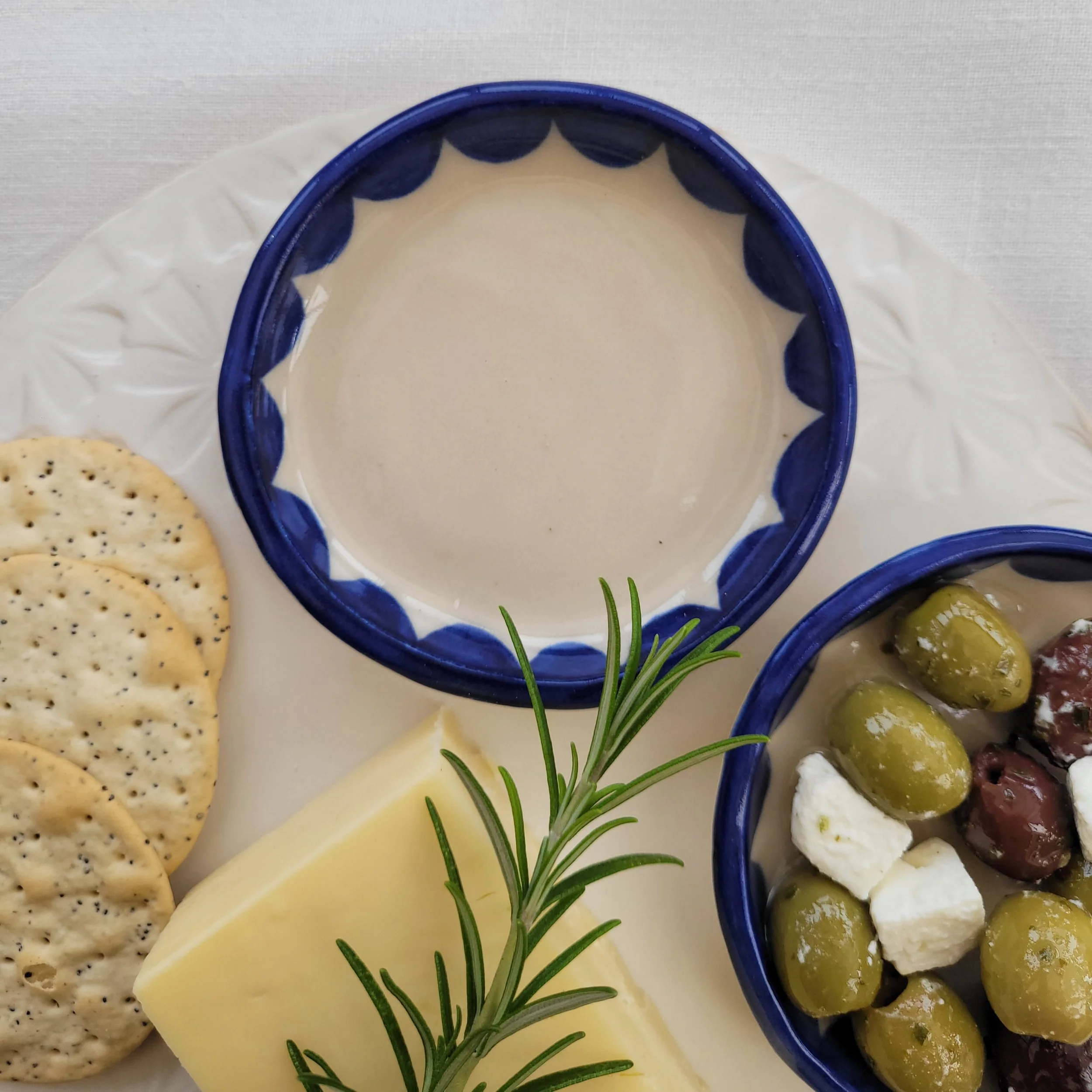 Blue scolloped dish with olives