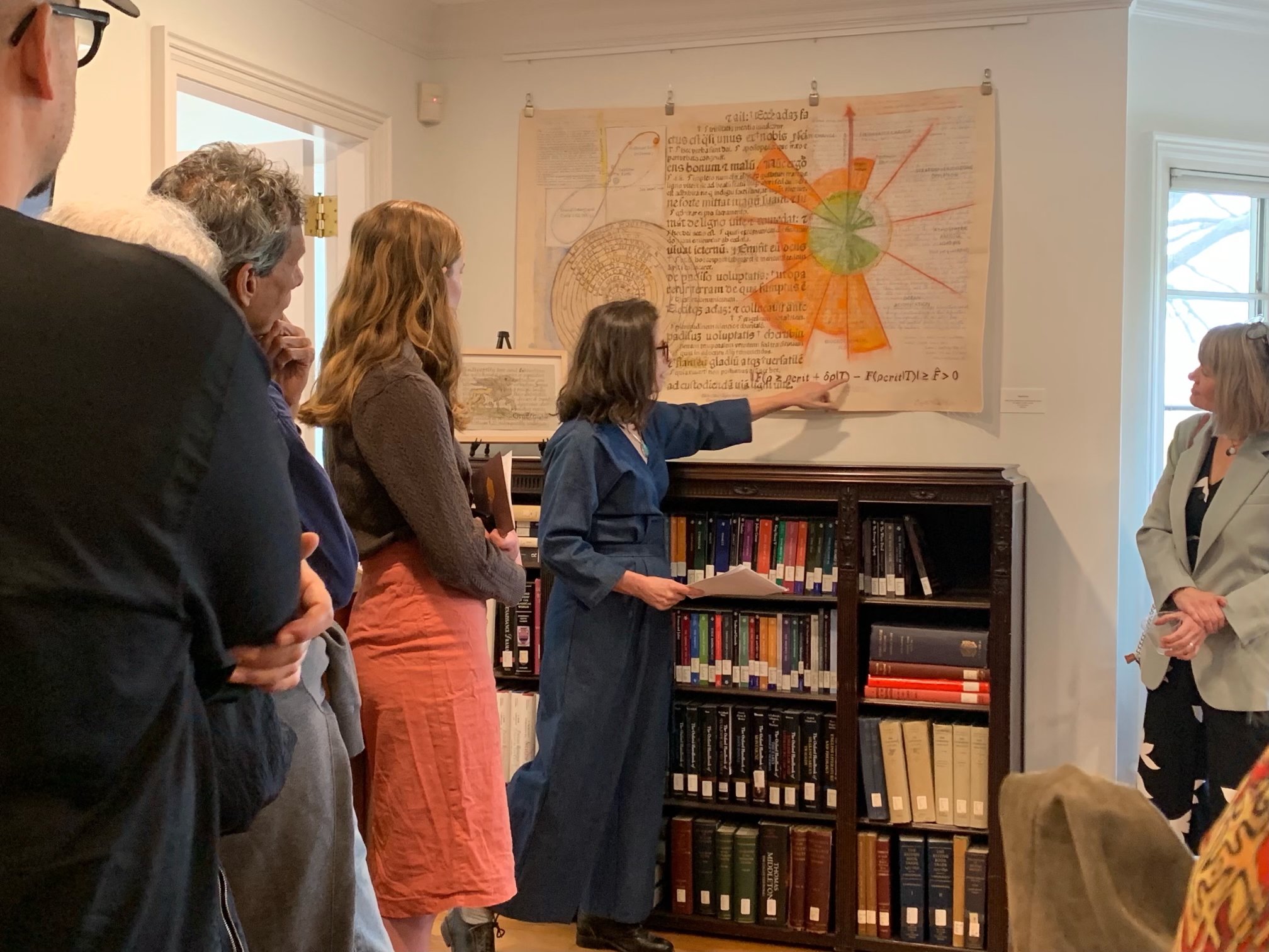 Students and members of the Amherst community listen intently as artist Suzette Marie Martin discusses her process, interspersing images and text from current IPPC reports with images from early modern earth science and geological studies and the Vu