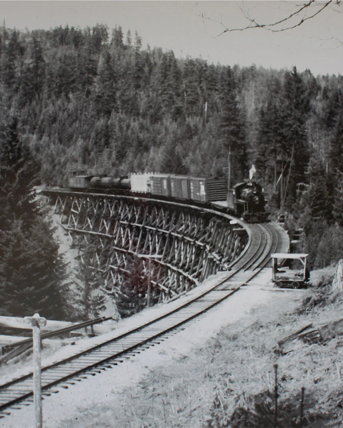 This Kinsol Trestle signboard shows a CNR freight train heading south to Victoria. A repair crew's "speeder" is parked alongside the tracks.