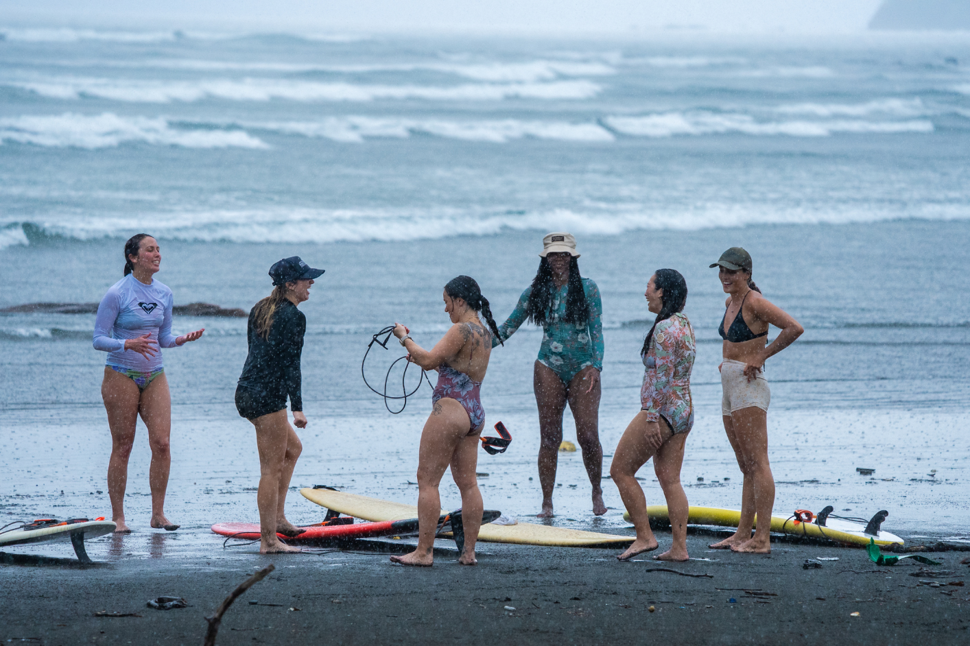 girls laughing in a rainy surf session