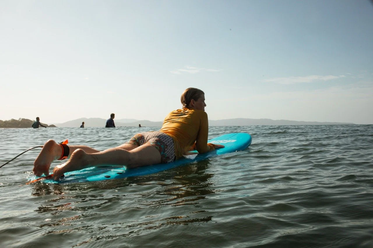 5 Reasons to Join a Surf Retreat (Even if You’re a Beginner) 3 Waiting for the next perfect wave at Estero Beach