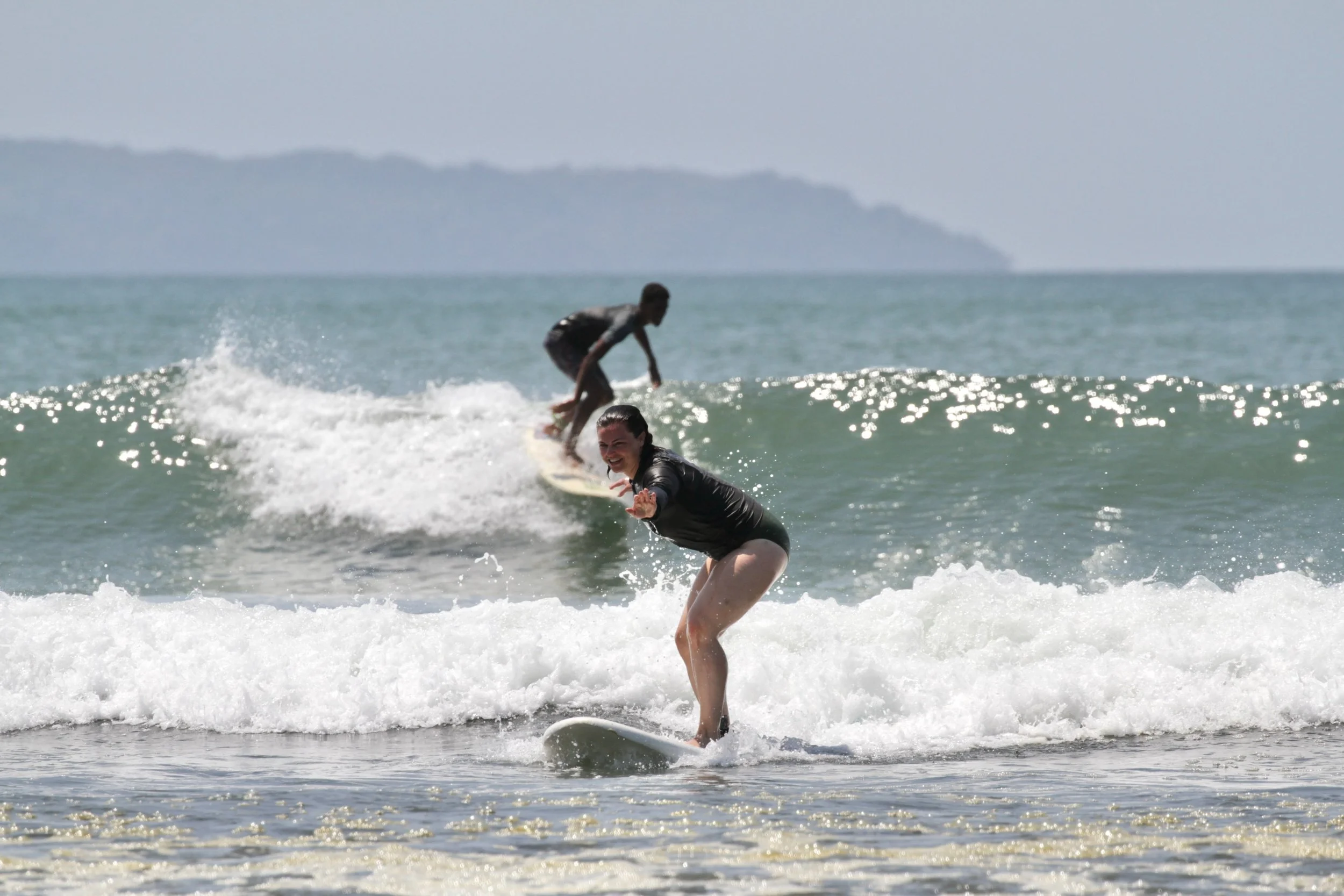 The Waluaa Guide to Surf Etiquette & Navigating the Lineup 5 girl+surfing+and+guy+surfing+in+the+back
