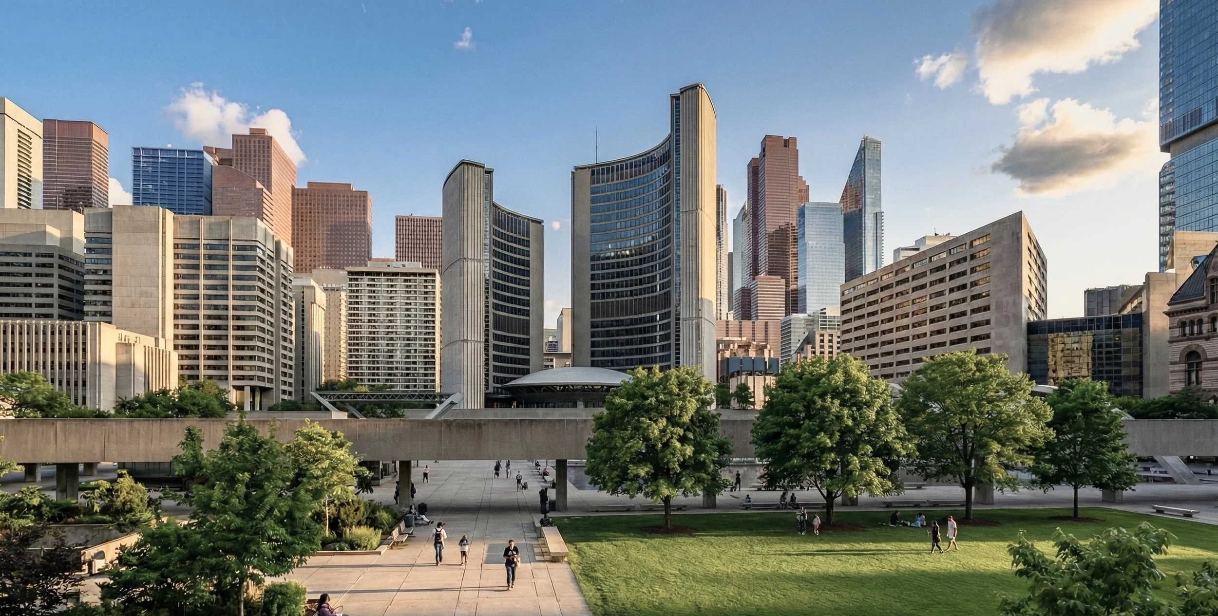 Cityscape with tall office buildings, a park with green trees and grass, people walking and sitting, under a partly cloudy sky.