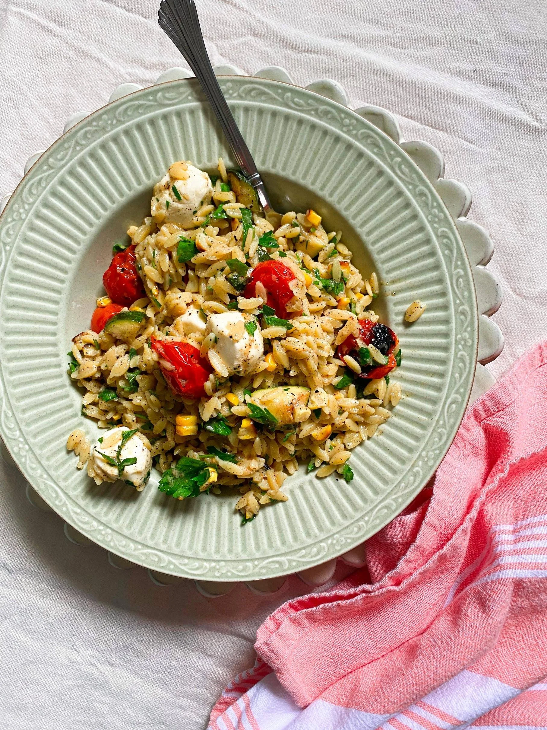 A decorative plate of a dish called Grilled Summer Vegetable Pasta Salad with Charred Sweet Onion Dressing