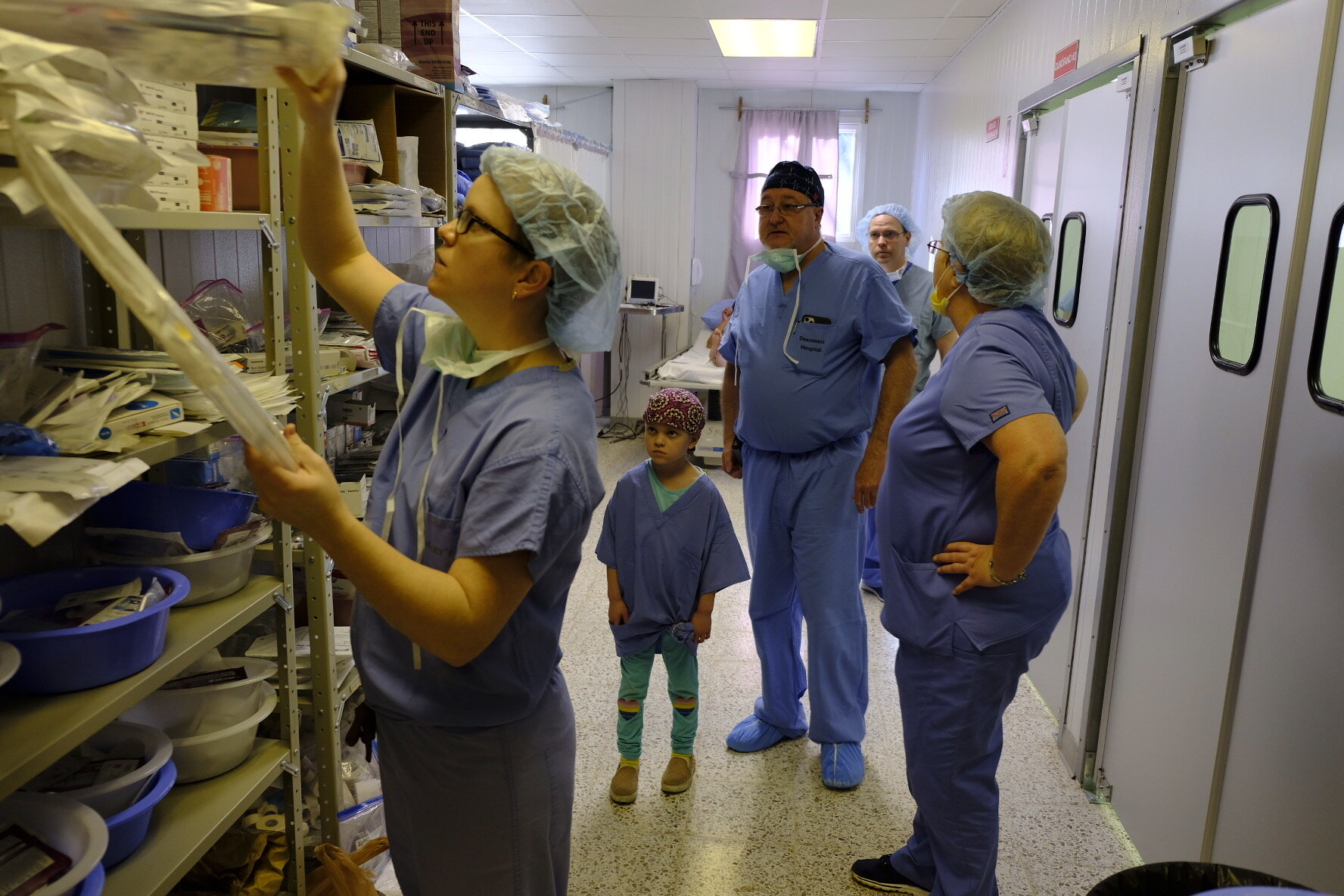  Dr. Angela Martin, ( foreground ), Lexie Martin, Dr. Don Patterson, Kerwyn Martin, and Valorie Qualey survey the surgical supplies. 