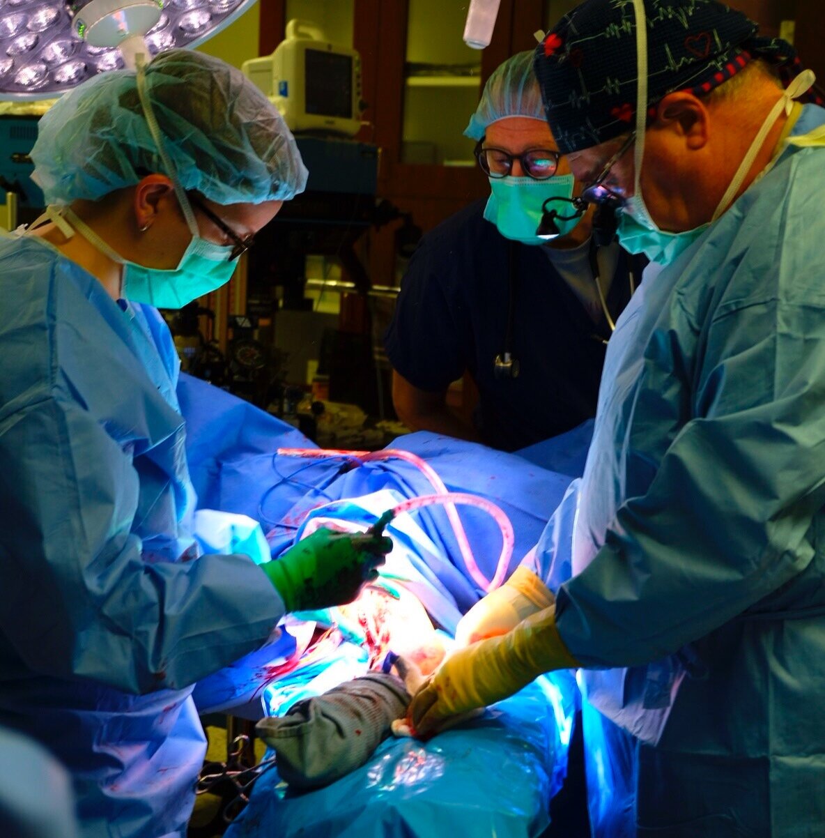  Dr. Angela Martin ( left ), anesthesiologist Mark Vickers ( center ), and Dr. Don Patterson ( right ) perform fistula surgery. 