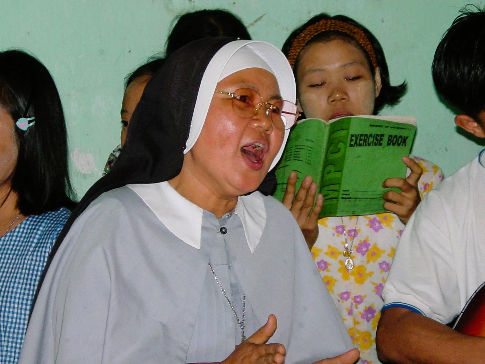 Woman singing in Myanmar - Travels of Brenda Shaddox of The Explorer's Club - Corner Cartel Boerne celebrates Women's History Month