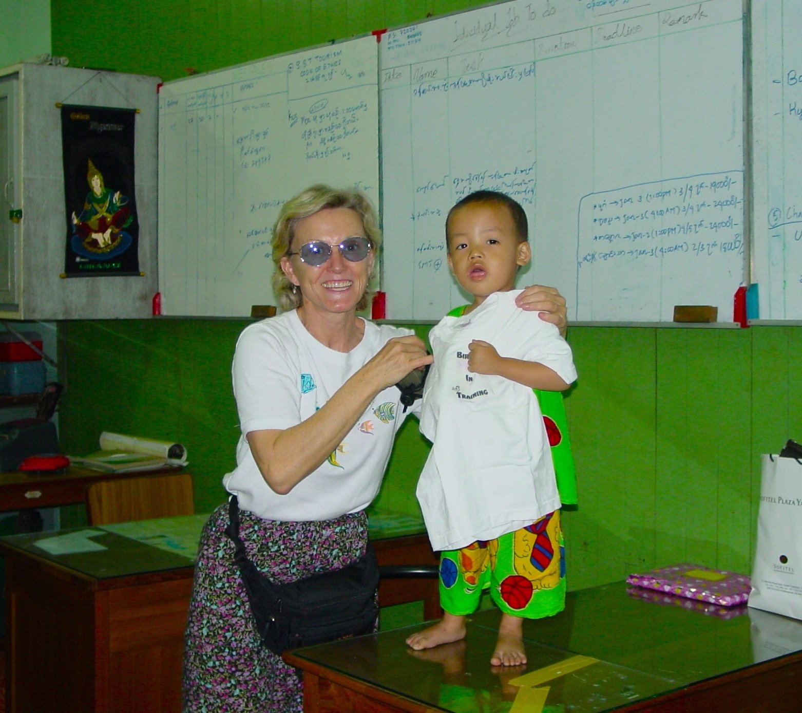 Brenda Shaddox with child in Myanmar - The Explorer's Club - Corner Cartel Boerne celebrates Women's History Month