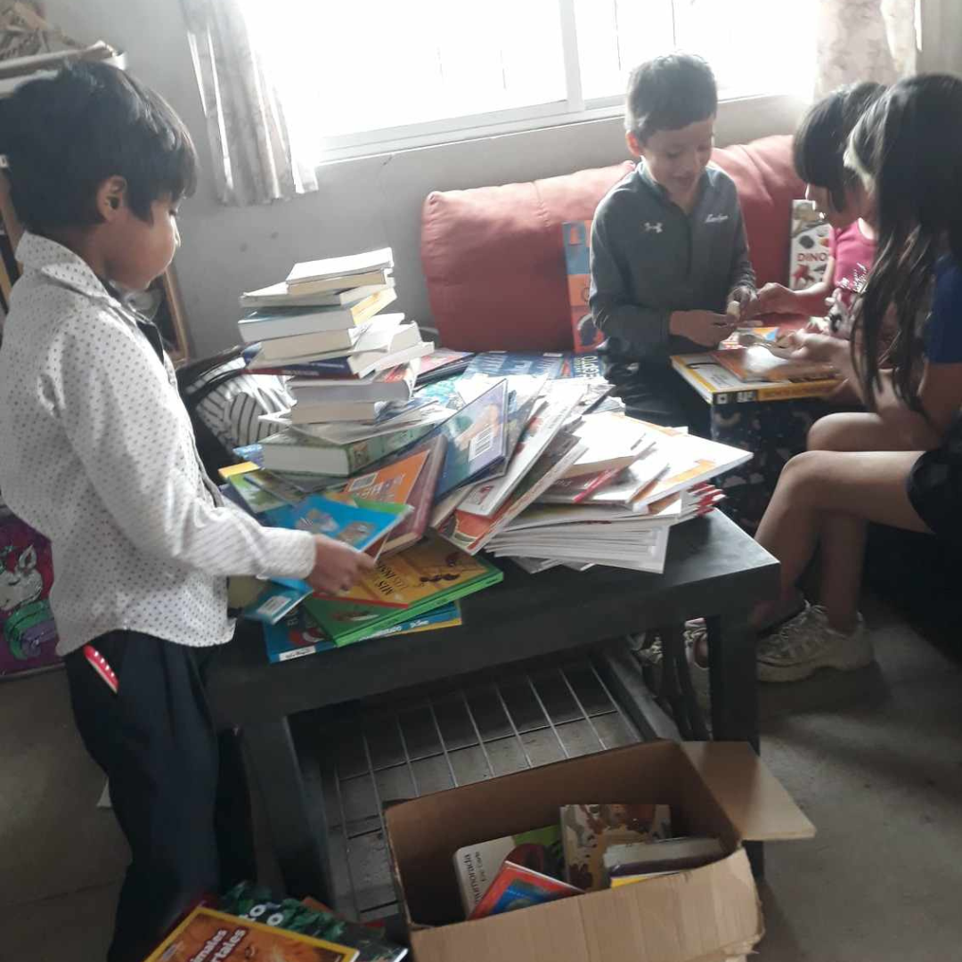 Children Choosing Books from the not-yet organized library