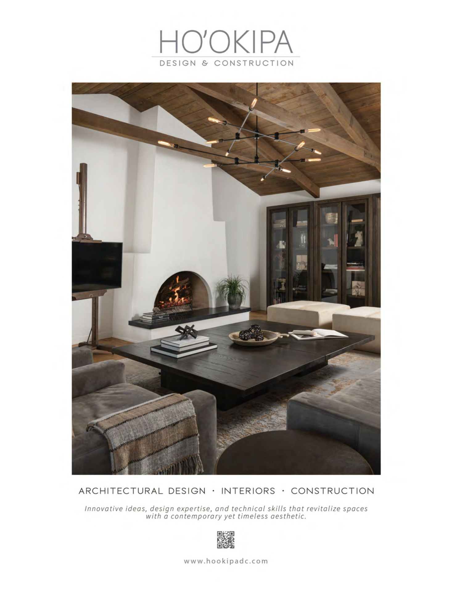 Interior living room with a modern black chandelier, wood beam ceiling, fireplace, dark wooden cabinet, and beige seating around a black coffee table.