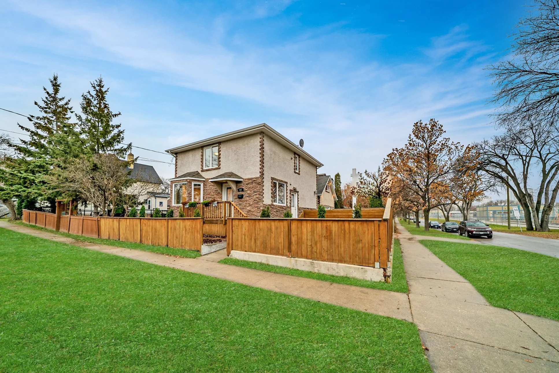 Residential corner lot with wood fencing beside the sidewalk