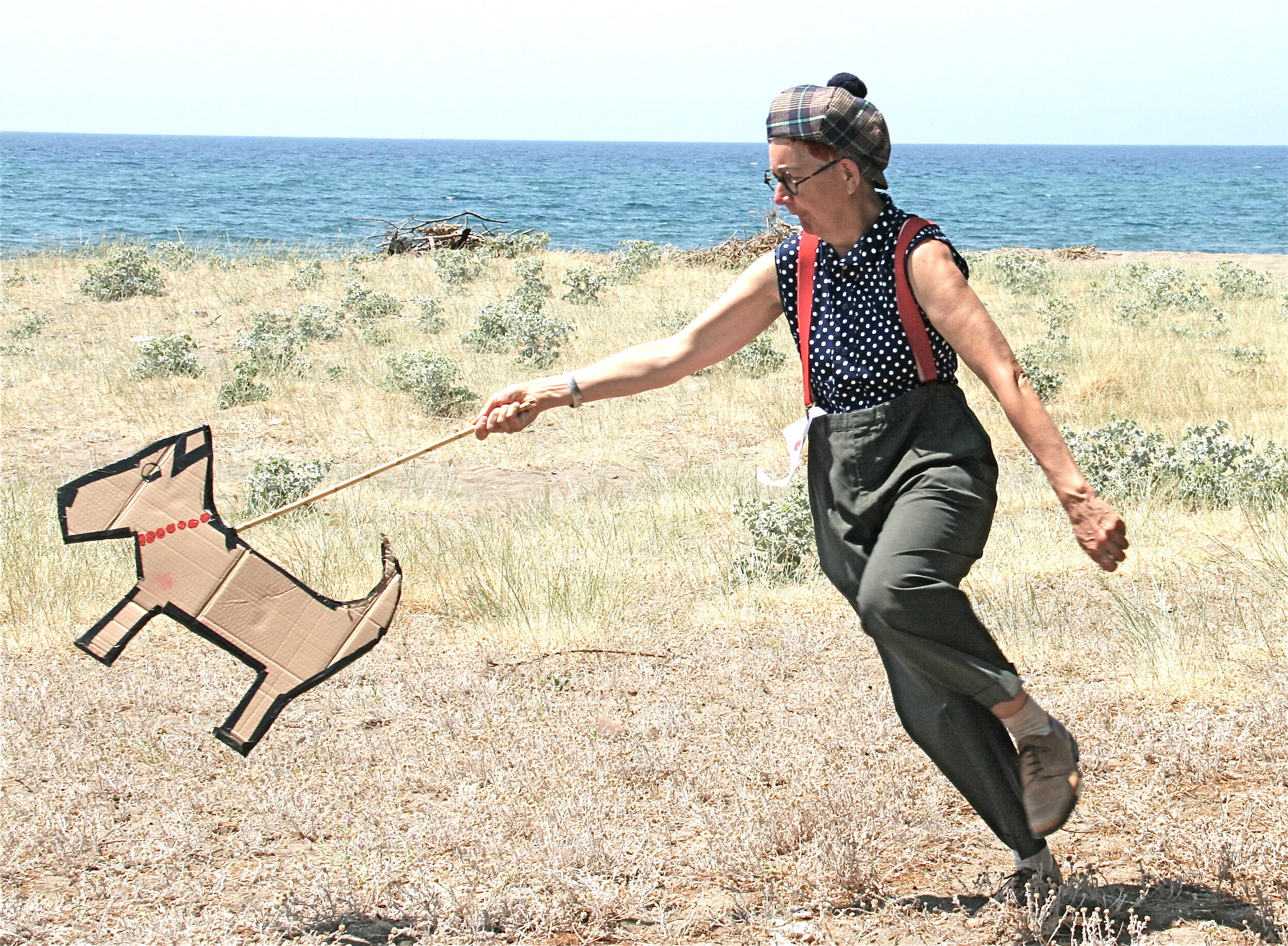 Dog dragging Nemo the clown at Sappho Festival of the Arts, Lesvos, 2014