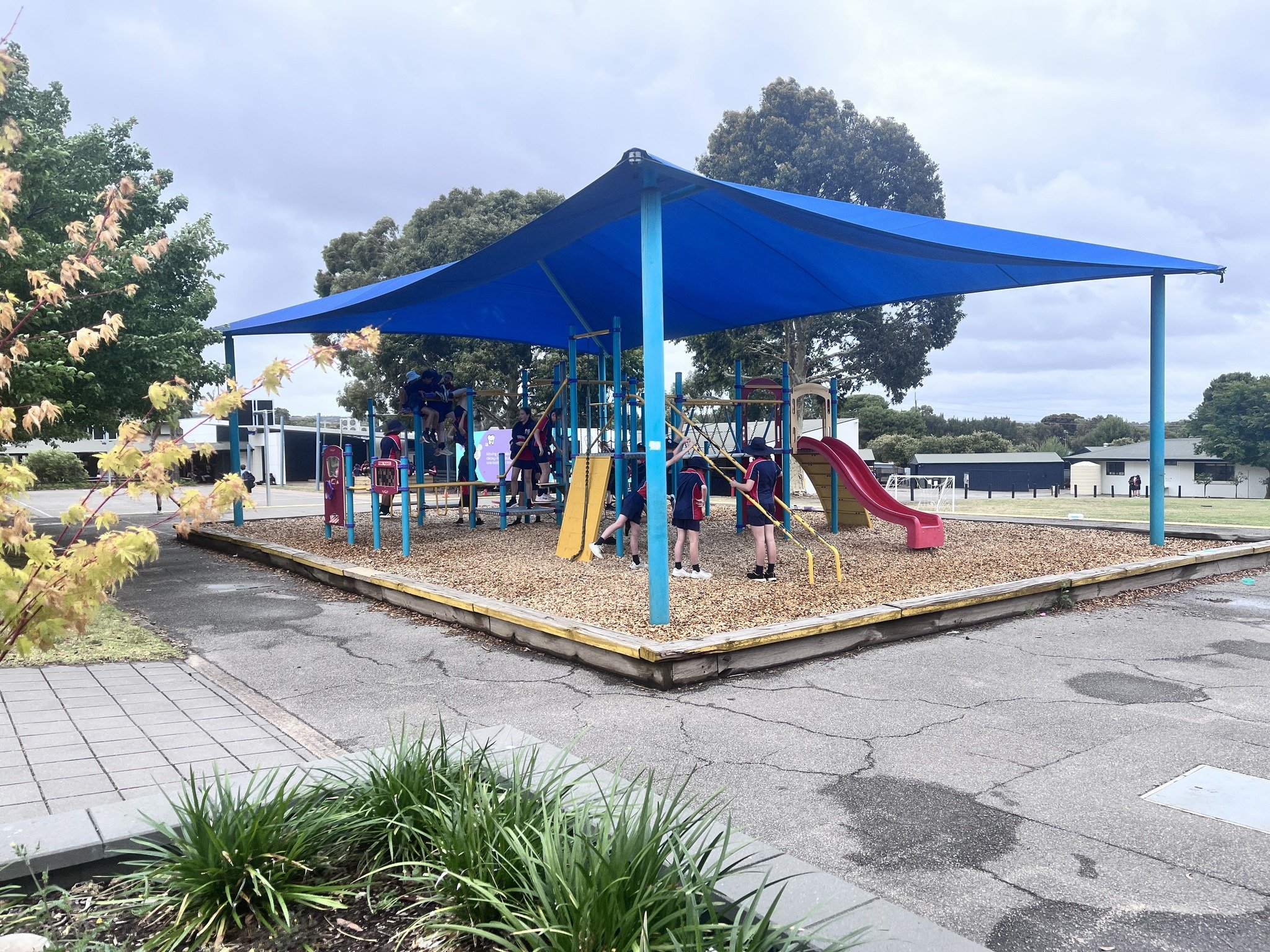 Students making the most of their recess with fresh air and fun in our covered play areas!