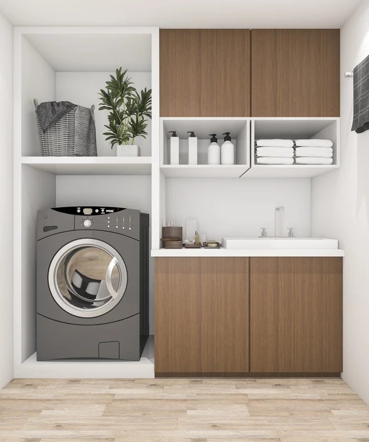 A laundry with woodgrain cupboards, white open shelving, a white bench top and a front-loading washer