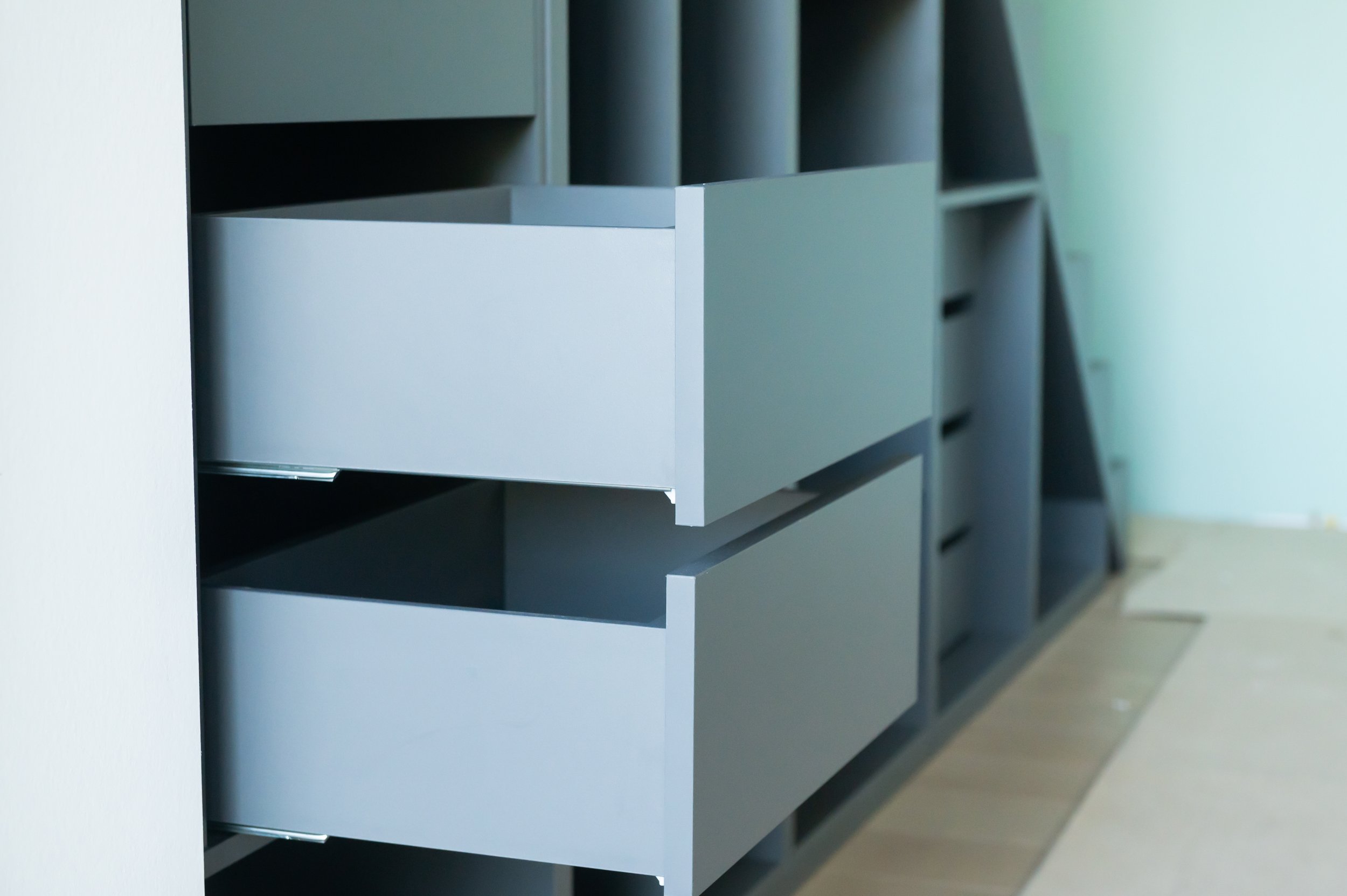 Blue drawers built under stairs