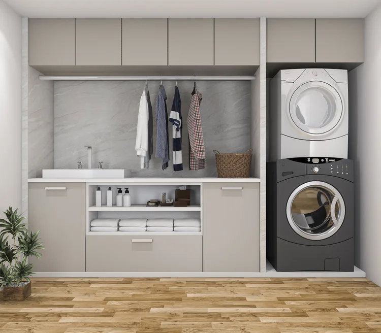 A greige laundry with a stone-look splashback, a built-in hanging rail and a stacked washer and dryer