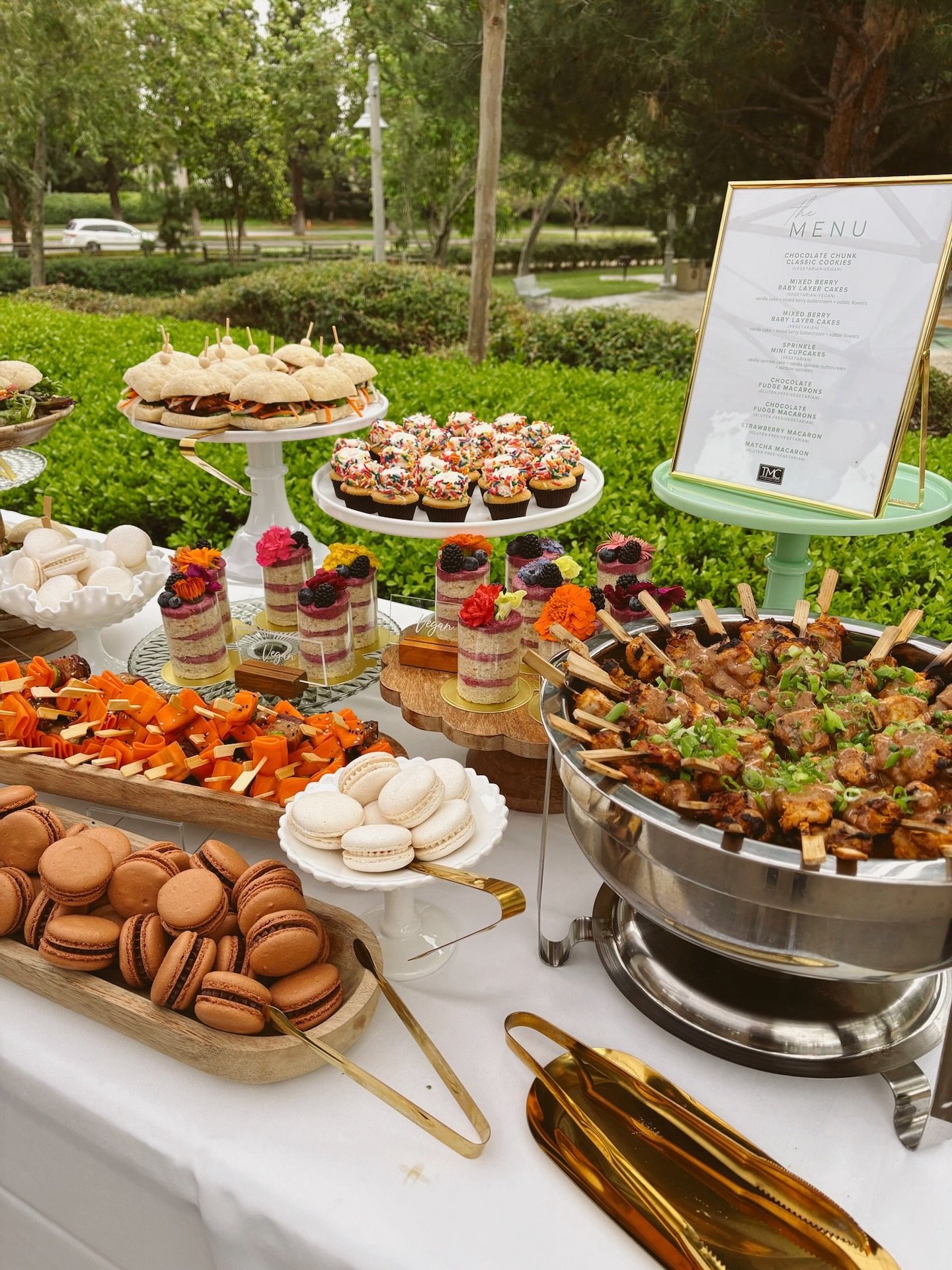 Whether you&rsquo;re planning a graduation celebration or an intimate garden party, TMC delivers a spread that&rsquo;s as delicious as it is stunning. From grilled chicken skewers to rainbow sprinkle cupcakes and matcha macarons, every bite is though