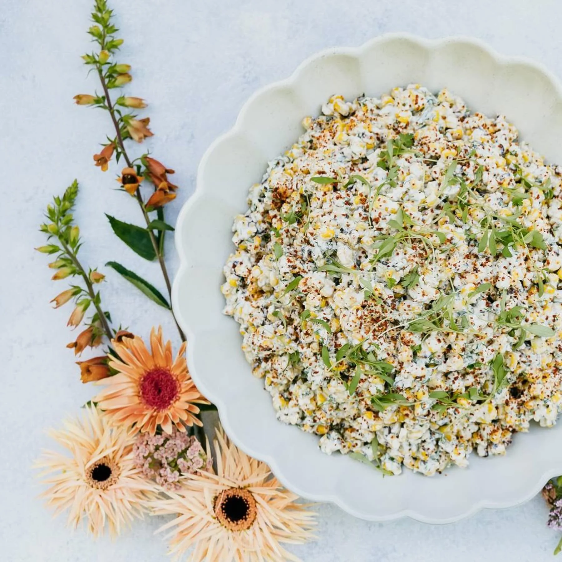 Street corn salad, anyone?! 🌽 

Grilled corn tossed with fresh jalape&ntilde;o, heirloom cherry tomatoes, cotija cheese, lime, sour cream, garlic aioli, cilantro, and a healthy shake of Tajin 🍋&zwj;🟩 

This fresh and flavorful salad is the perfect