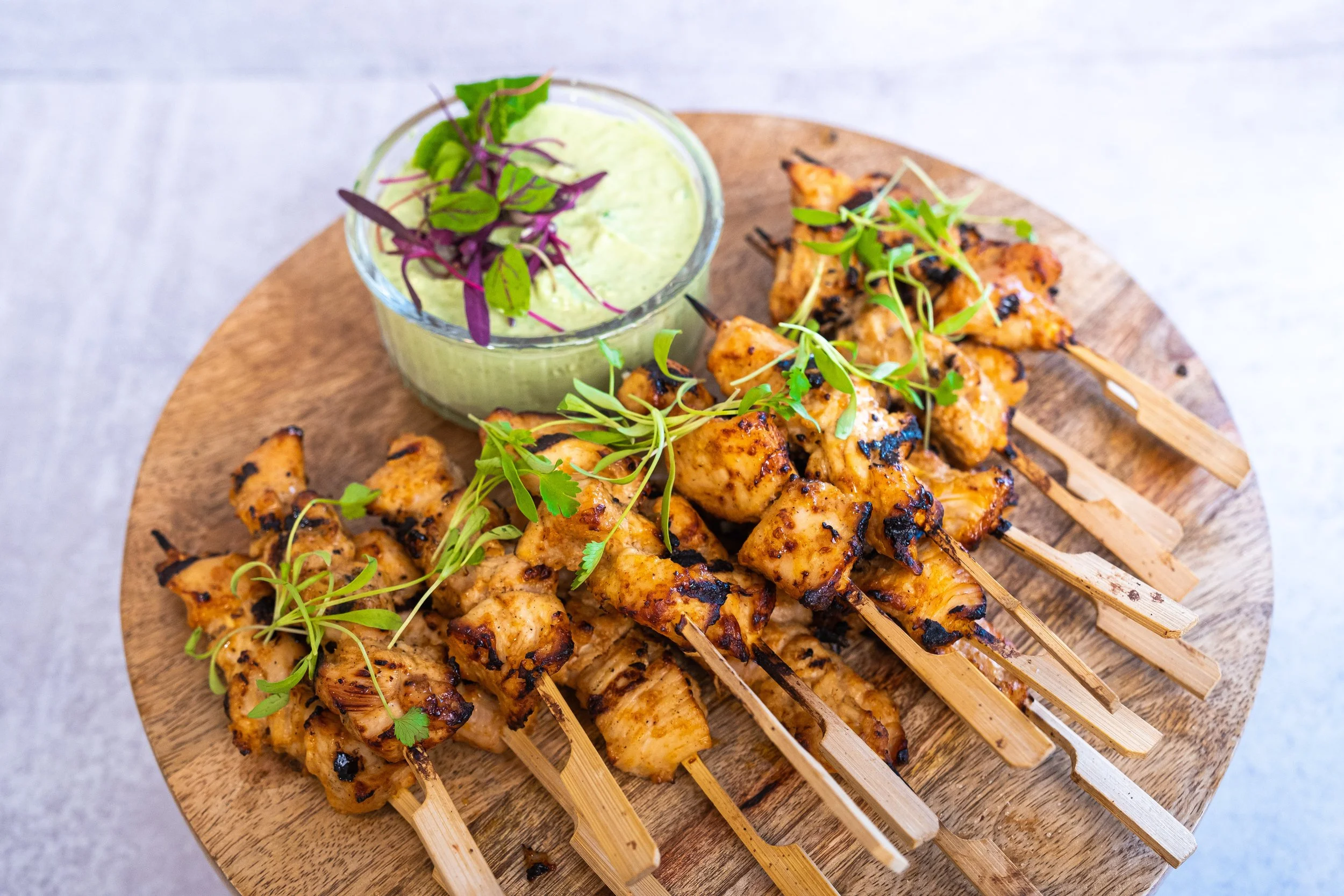 Grilled chicken skewers with dipping sauce served as catering appetizers by Taylor Made Cuisine
