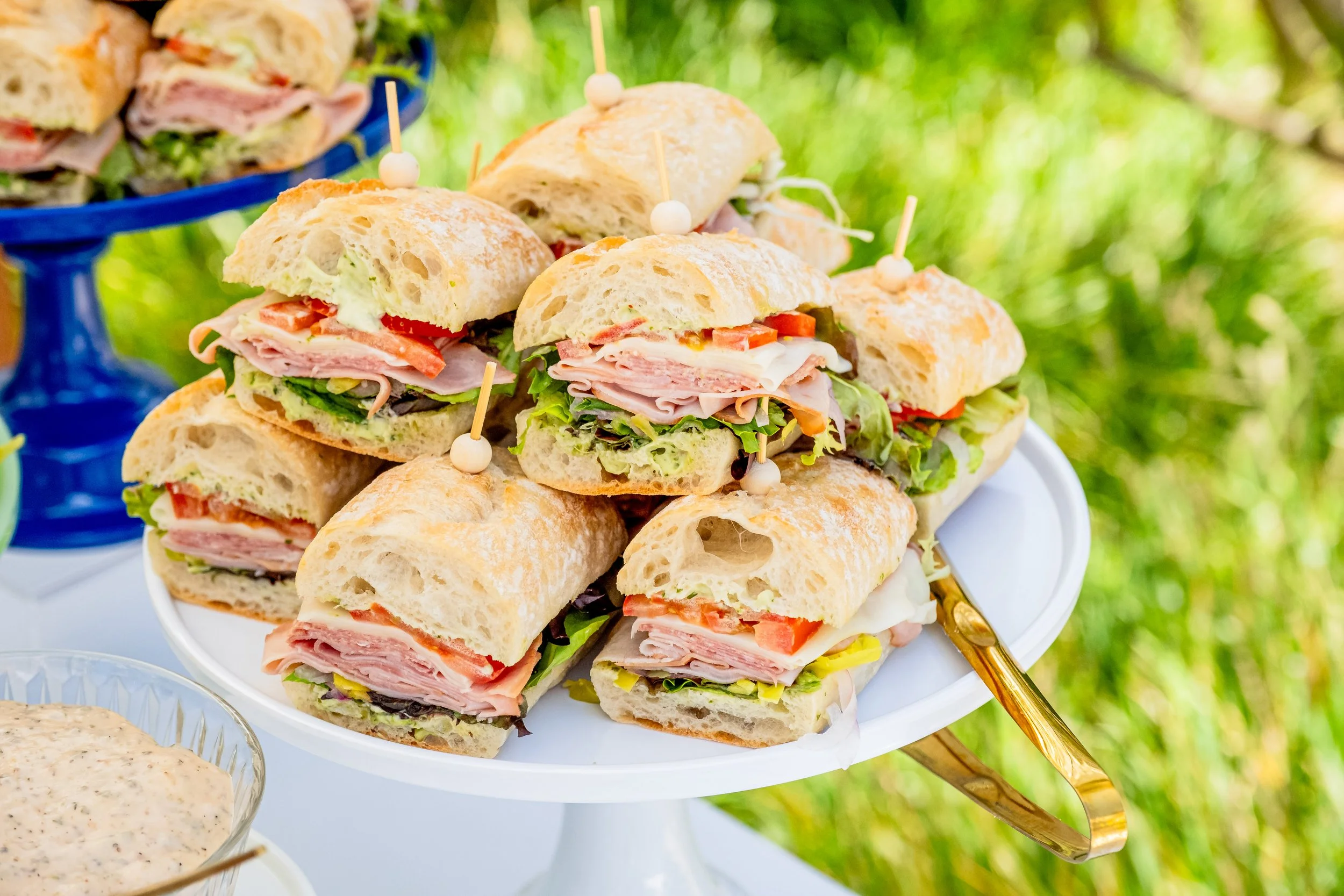 Mini sandwich sliders served on a catering display by Taylor Made Cuisine