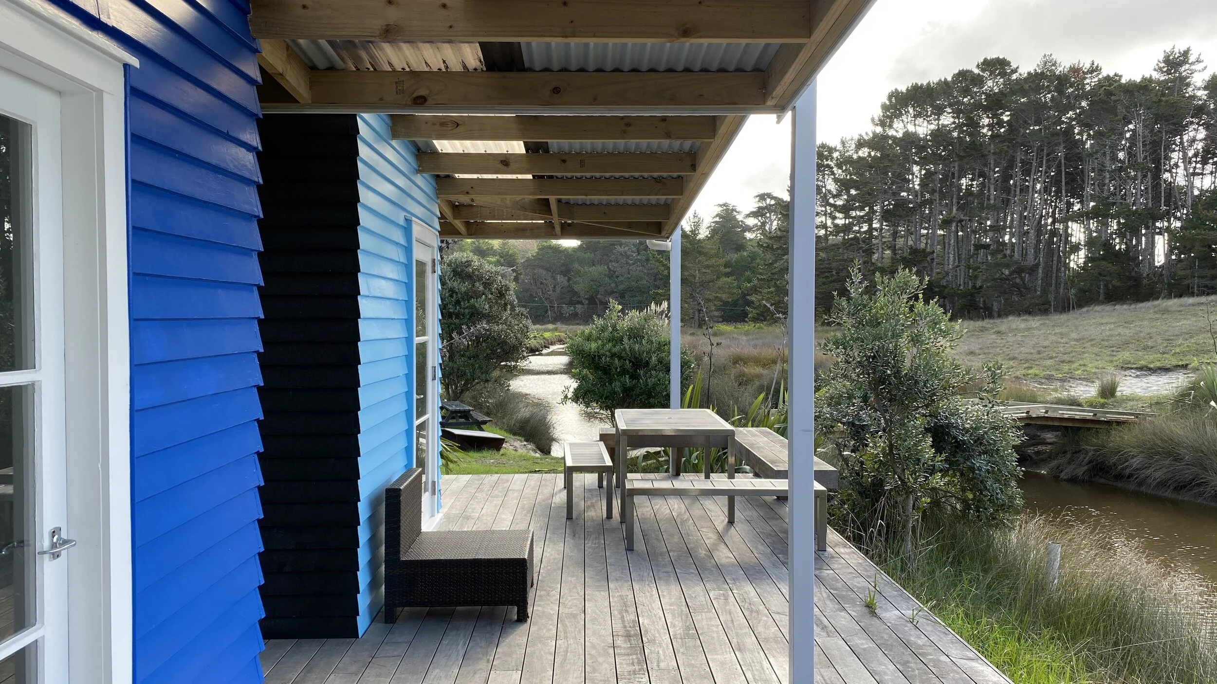 Pakiri Horse Riding Beach Cabins  Renovated to operate as holiday accommodation rentals at the iconic Pakiri Beach Horse Riding, these river side cabins were renovated with relaxation in mind. These are simple one bedroom cabins with kitchen and bathroom facilities, with the surrounding decking (also built by Tiny Living) adds extra living space for guests to enjoy the tranquil surrounds.
