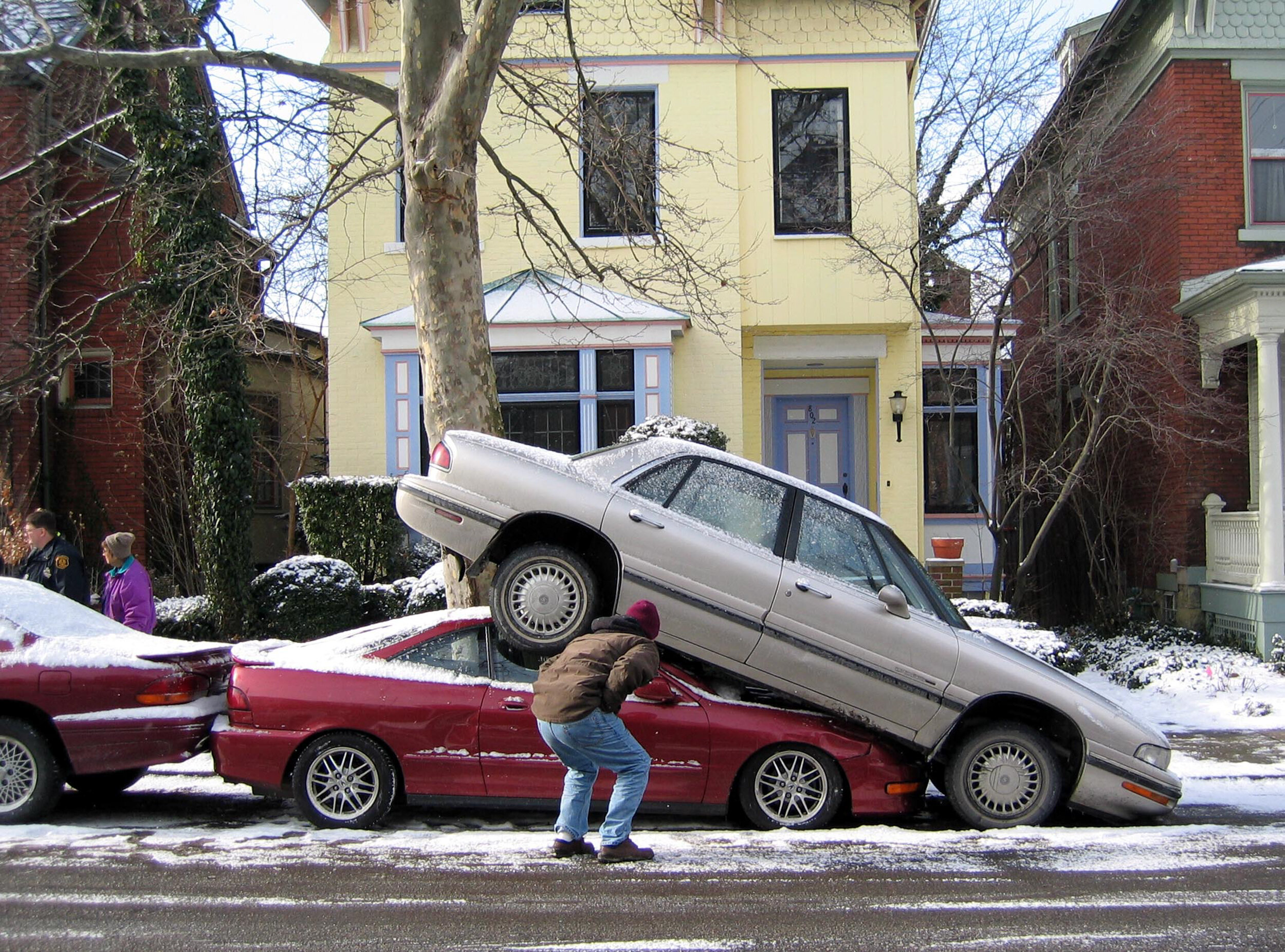  Car sandwich after car reversed over the top of another car, Pittsburgh, Pennsylvania.  Shot by Eleanor Bentall, London-based photographer. 