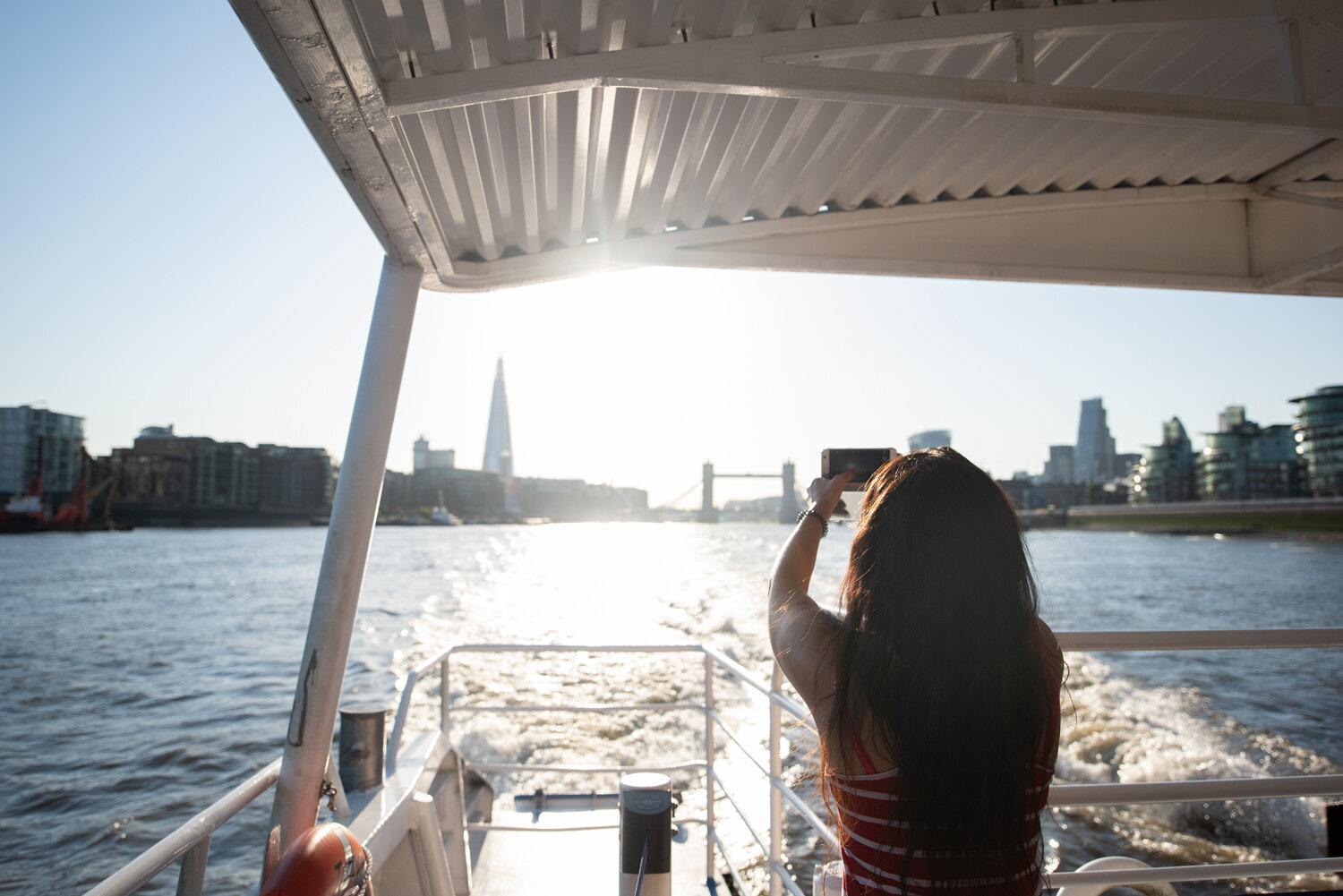  London River Services.  Passenger on Thames Clipper with view of Tower Bridge and The Shard.  Photograph by Eleanor Bentall, London based photographer. 