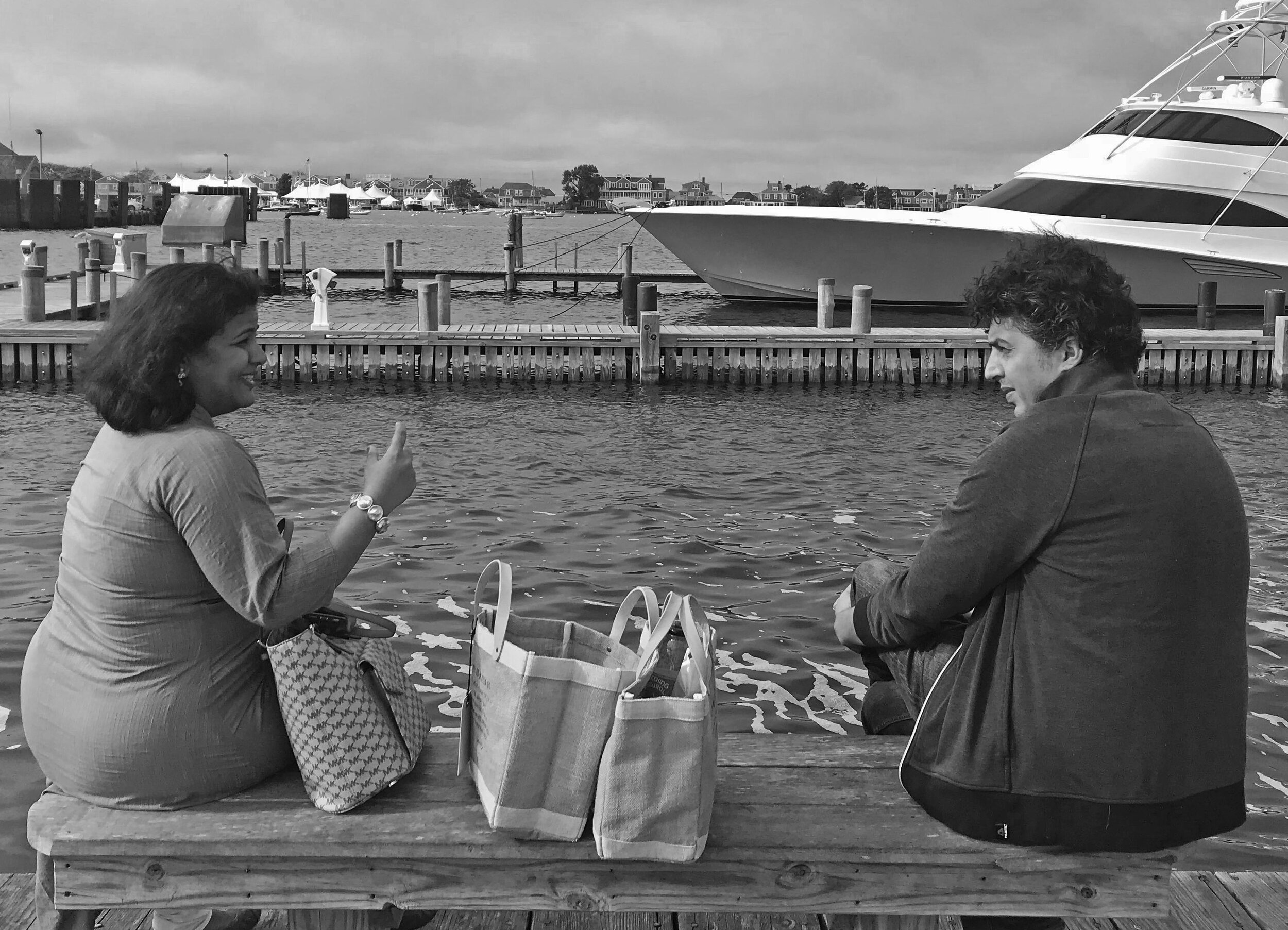 Sunayana Dumala and Sofian Khan sit and speak on a boat dock