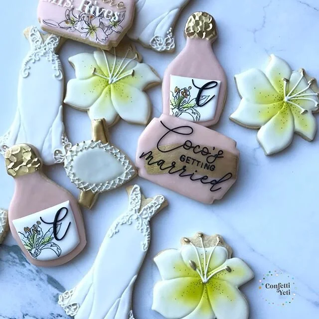 Lilies, pear shaped ring with a halo, and Coco&rsquo;s dress. A bridal shower tailored just for her.

Pear ring is hand cut. The pistils on the lilies is painted with highlighter gold from Truly Mad Plastics

#confettiyeticookies #bridalshowercookies