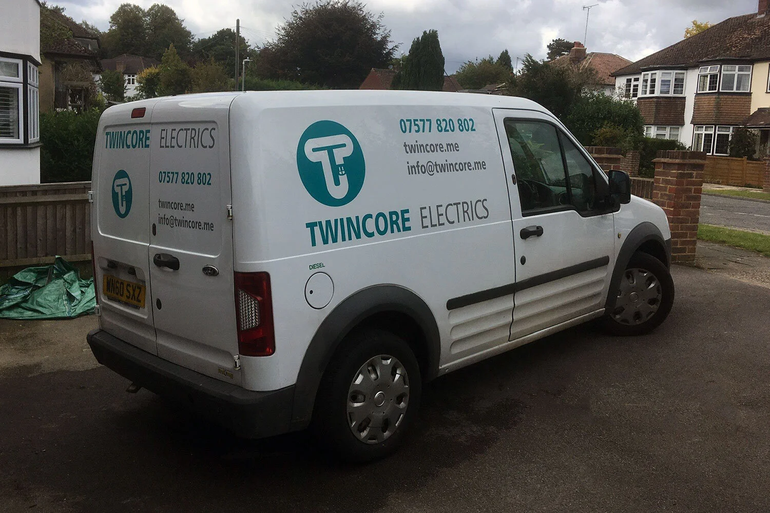 A white van with Twincore Electrics branding parked on a residential street in Bromley.