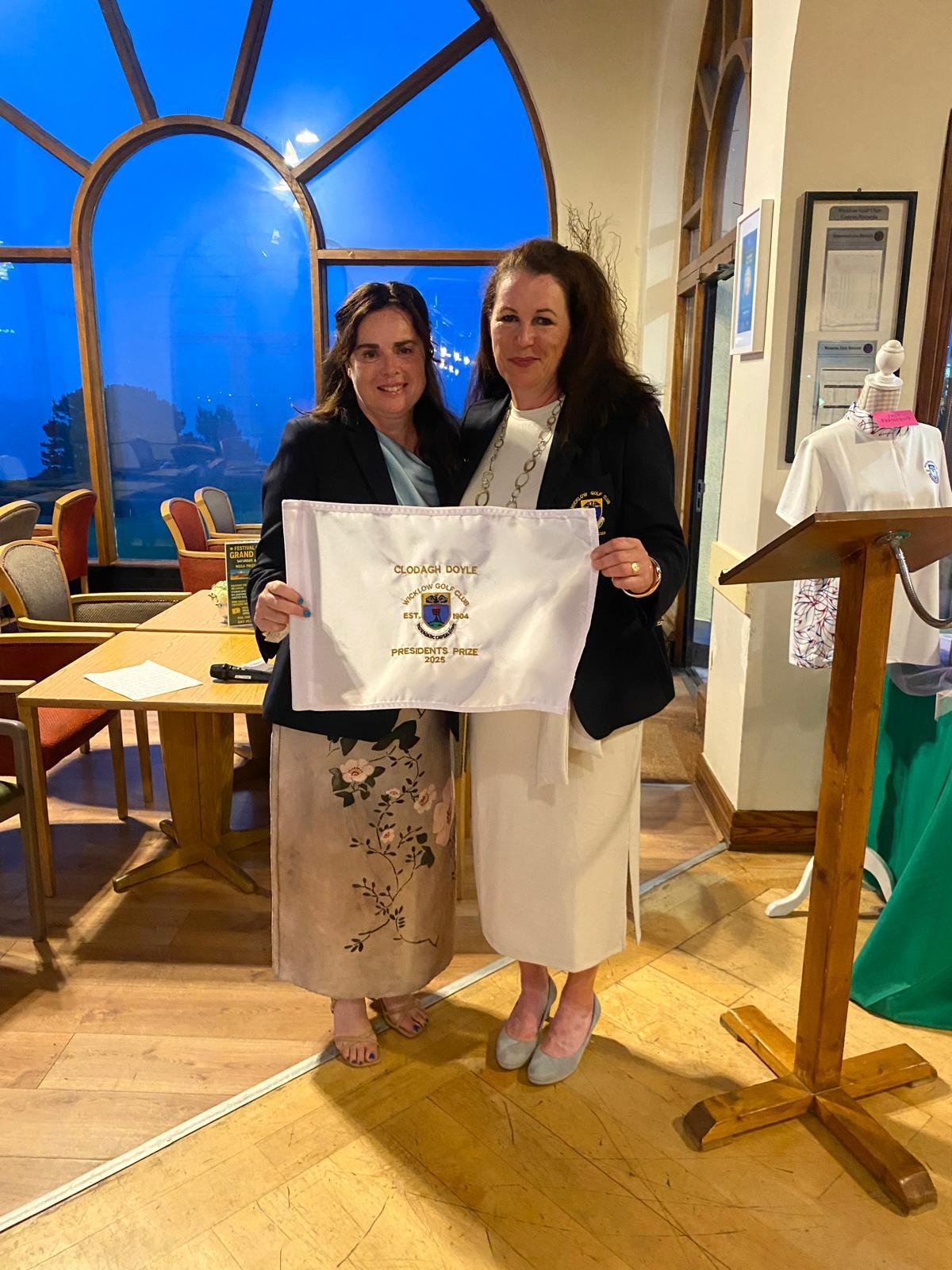 Captain Paula presents the flag to President Clodagh