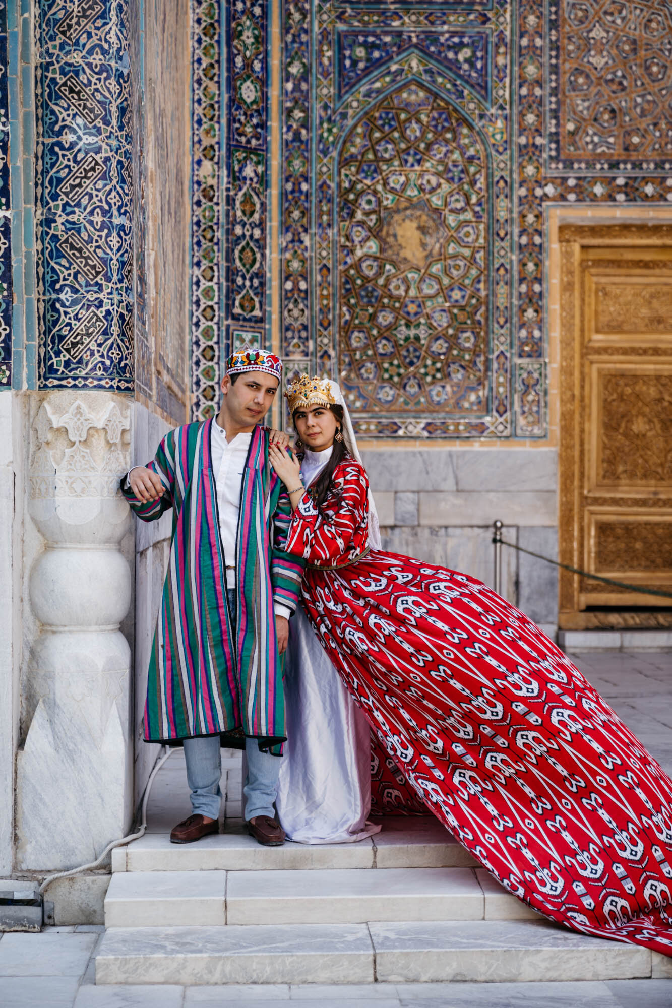  A couple in traditional Uzbek clothing at the Sher-Dor Madrasah, Samarkand 