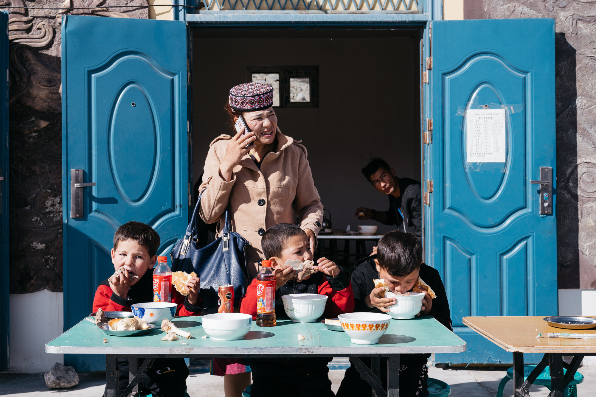  Pit-stop on the road to Kashgar. Most of the inhabitants of western Xinjiang province part of an Turkic minority ethnic group originating from and culturally affiliated with the general region of Central and East Asia. This lady is wearing a traditi