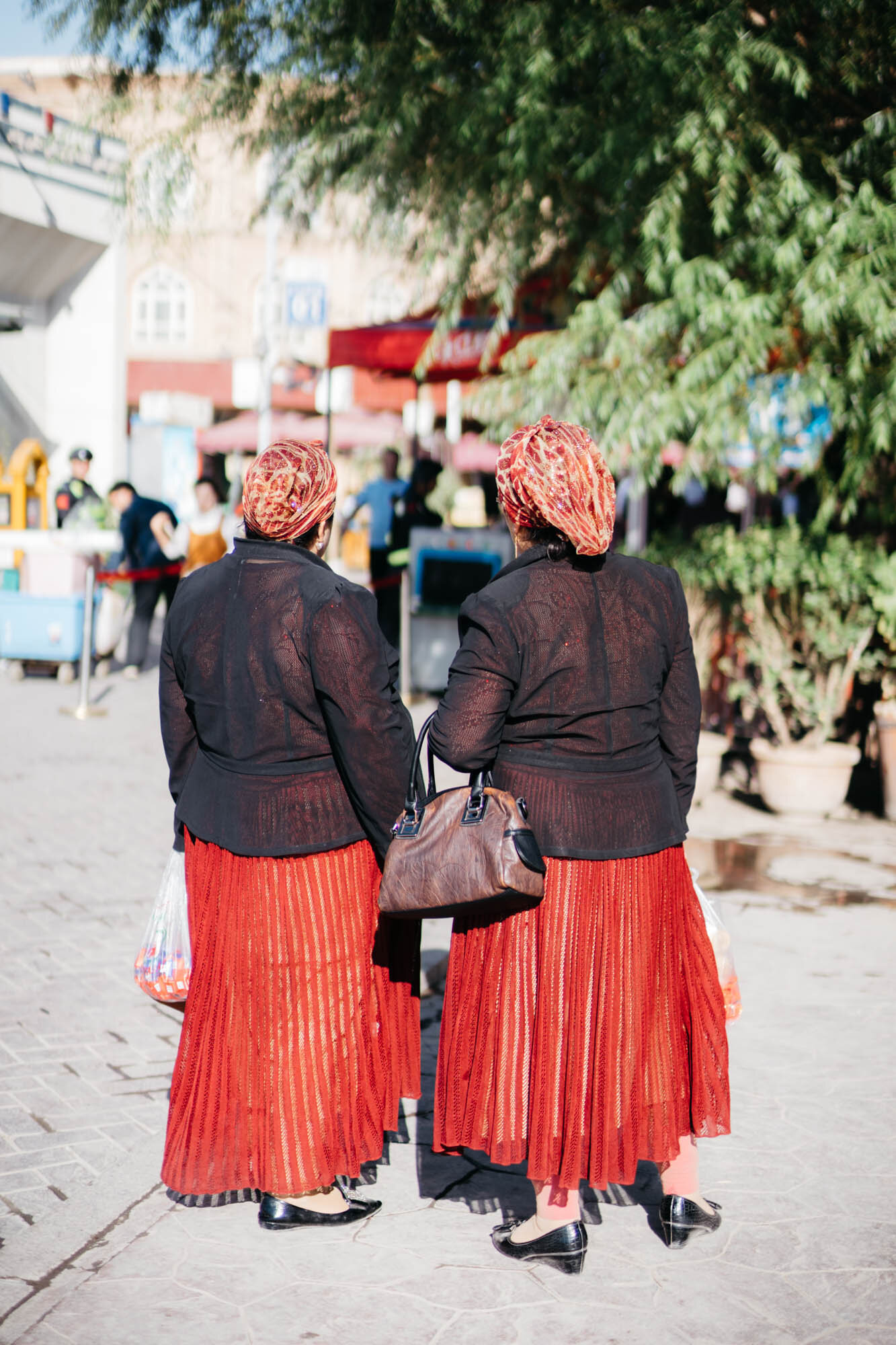 Two Uyghur women in matching outfits