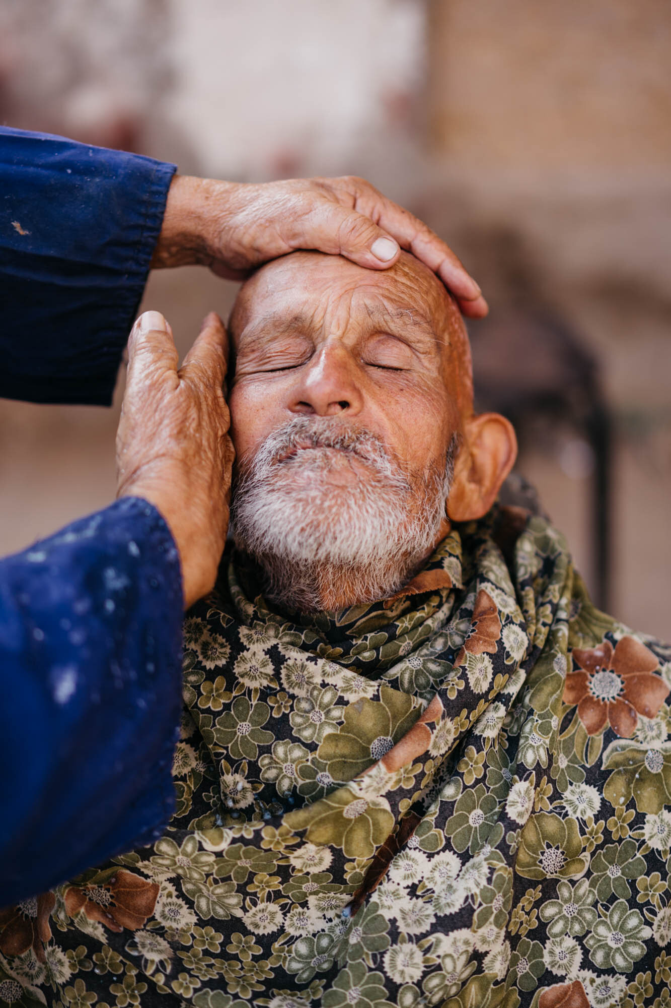  A barber giving face massage at the bazaar 