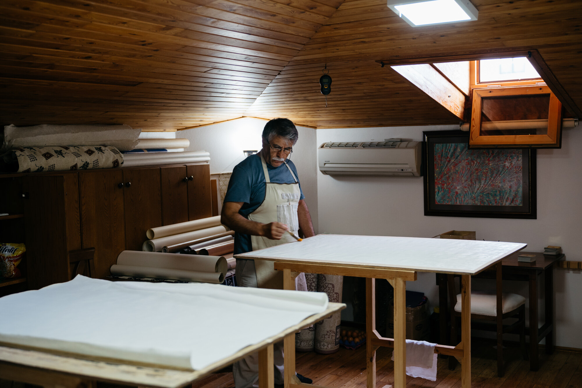  One of Ayten's family members preparing paper for calligraphy and illumiation. He is covering the paper with a thin layer of egg white. 
