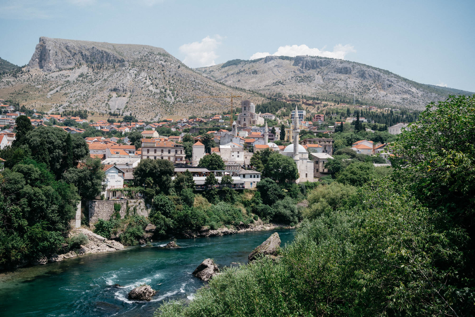  Mostar on the Neretva River. The city is home to a variety of different mosques and churches. Top centre you can see a new cathedral is under construction. 