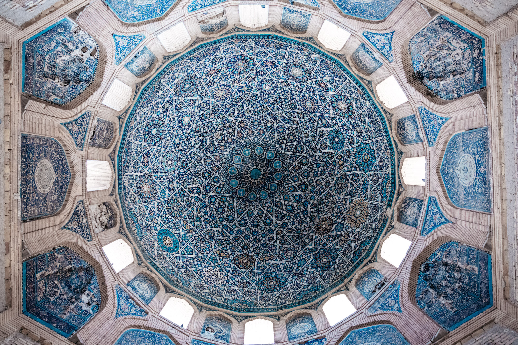  Inside of the dome of the Turabek-Khanum Mausoleum. The surface is covered in colourful mosaic which forms intricate ornamental patterns consisting of flowers and stars, creating a visual metaphor for the heavens. 