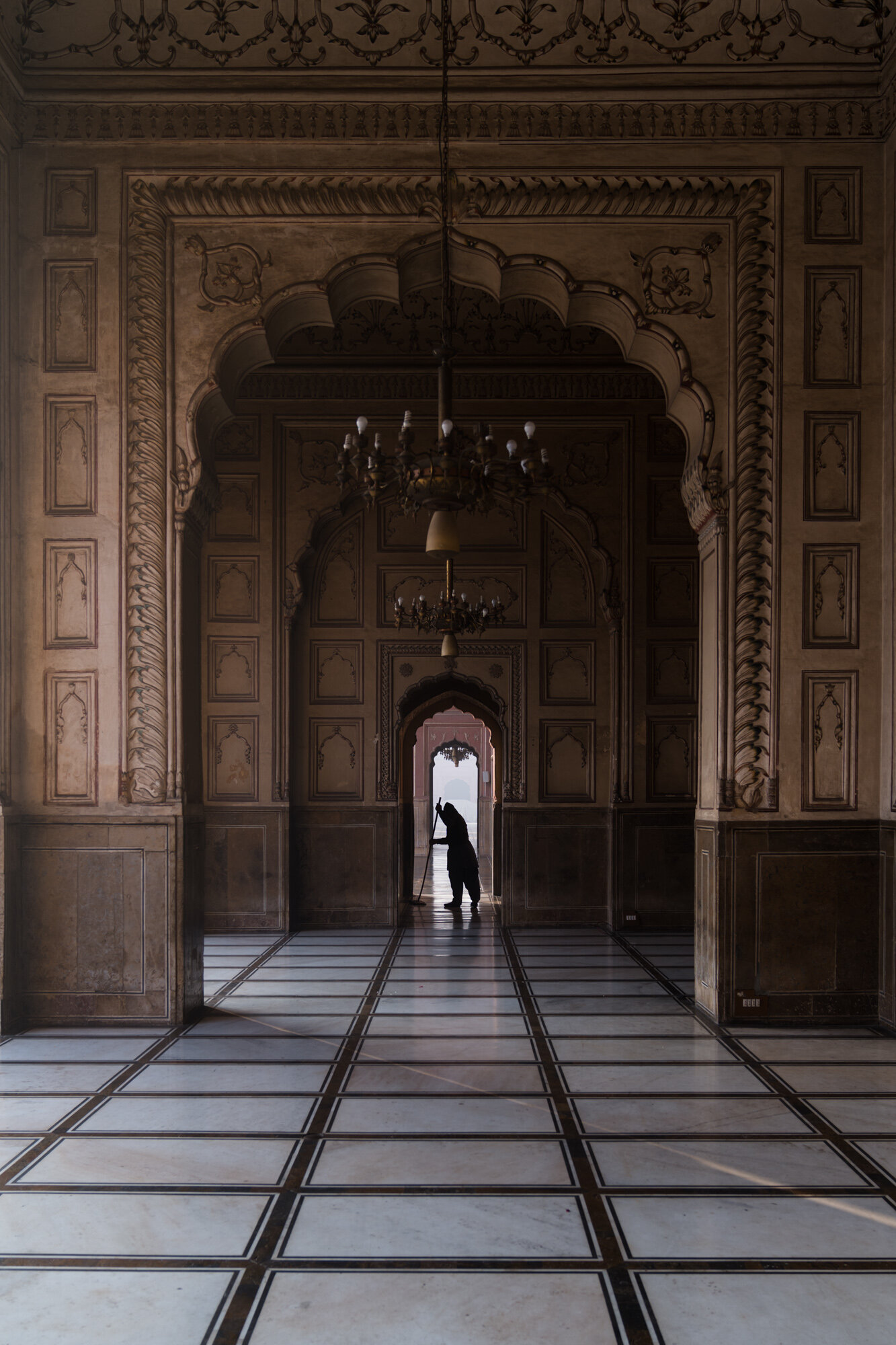  A man cleaning the floors before worshippers arrive 